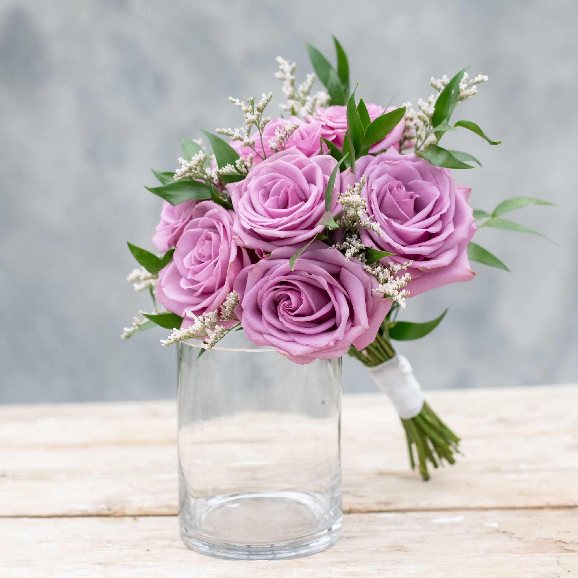 Eight roses with just a hint of greenery. You choose the color