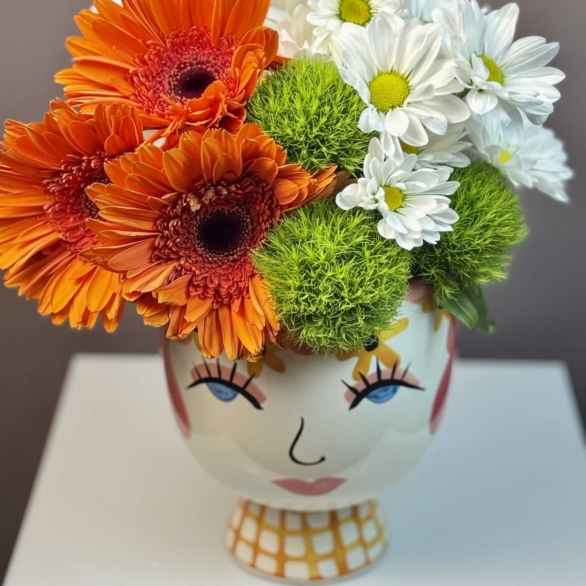 This cheerful arrangement is designed to bring a playful burst of personality