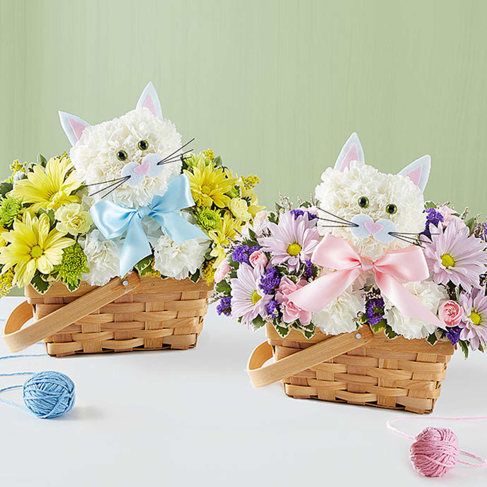 Two flower baskets with cat faces and pastel bows