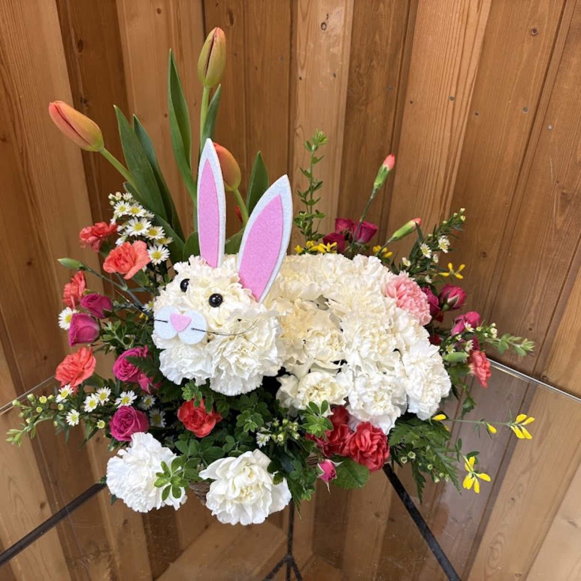 Floral arrangement shaped like a bunny with pink ears and white flowers
