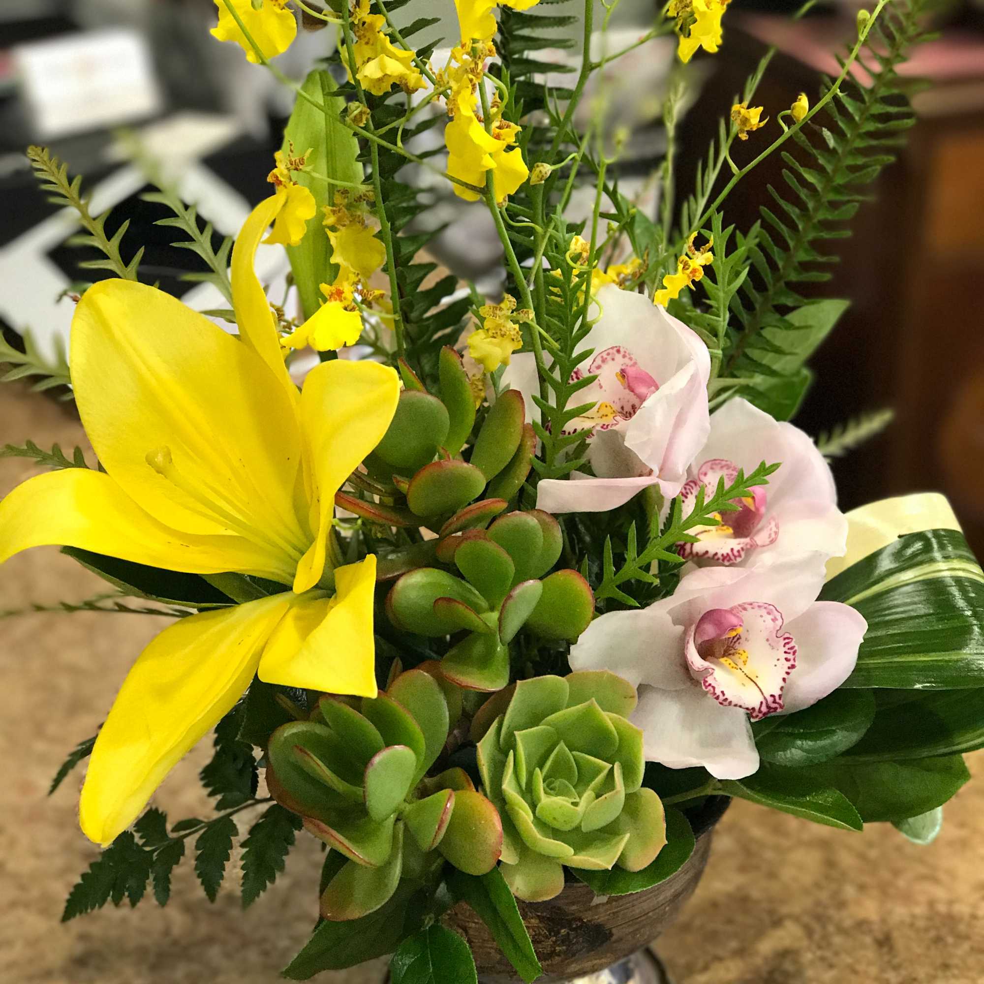 Sunlit yellow orchids and a single bold yellow lily rise above clusters