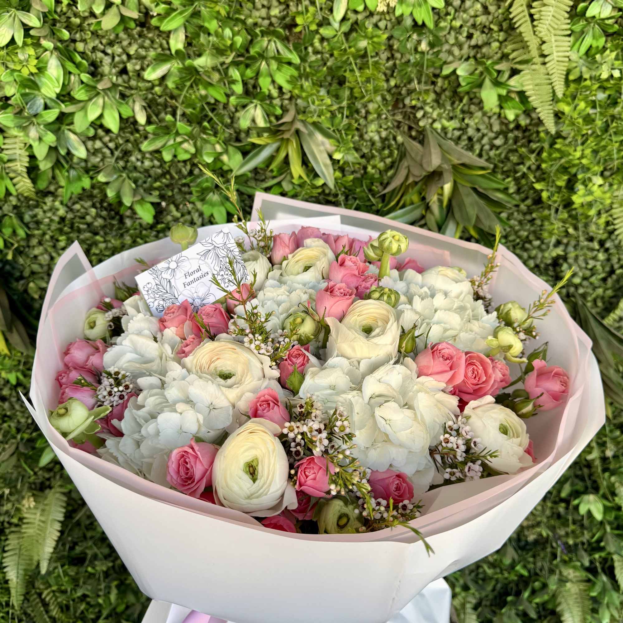 An elegant floral arrangement featuring a blend of pure white and vibrant