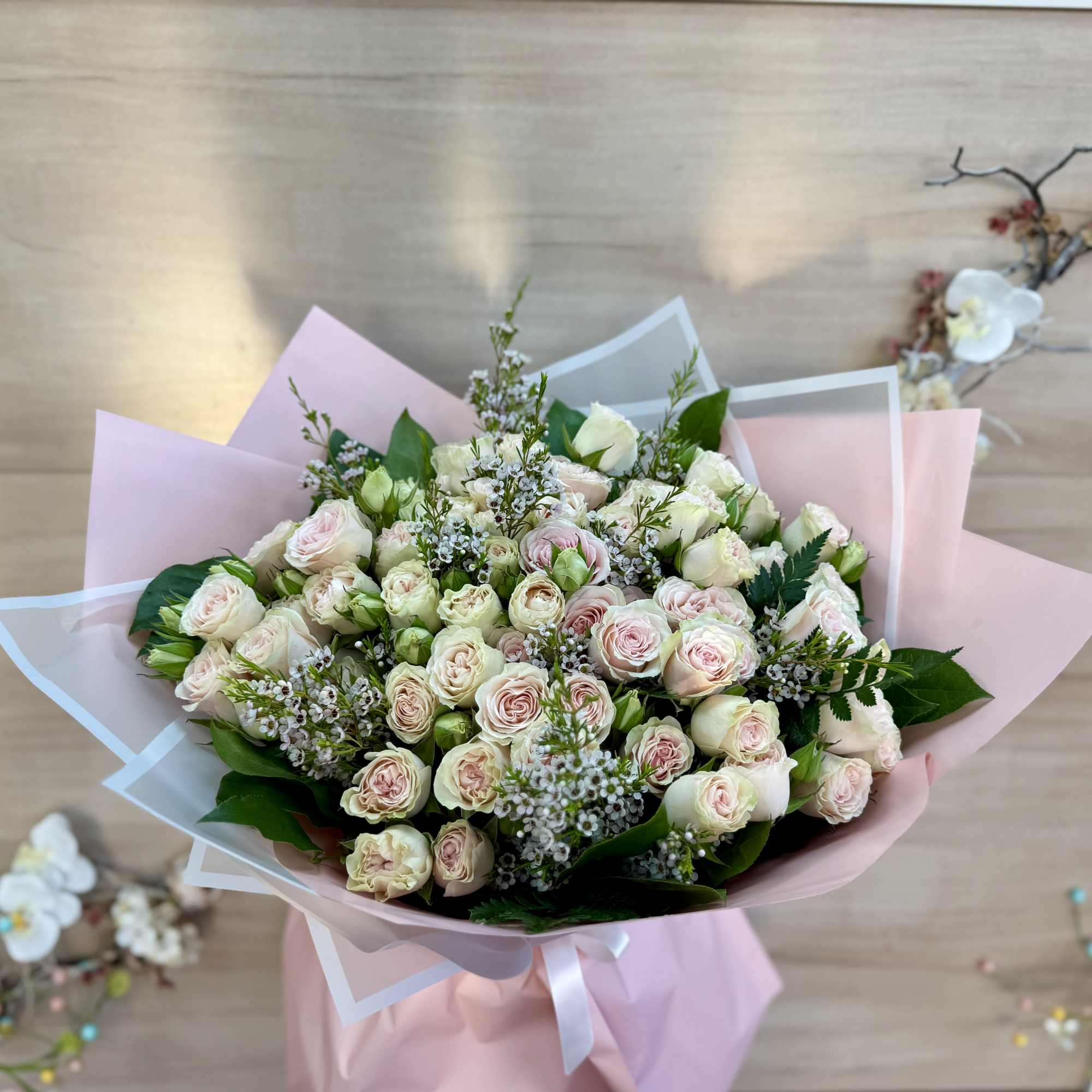 An elegant floral arrangement featuring a blend of pure white and vibrant