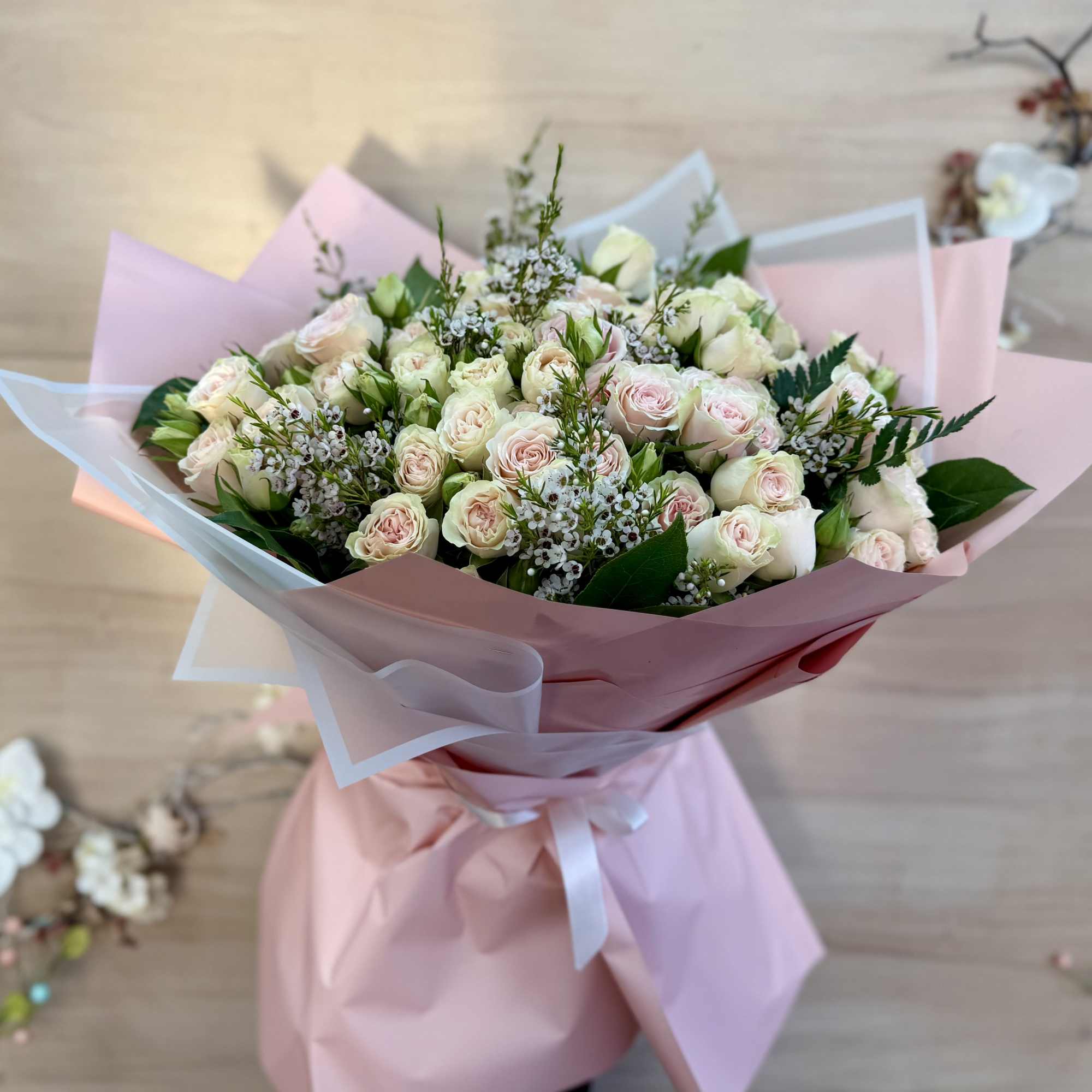 An elegant floral arrangement featuring a blend of pure white and vibrant