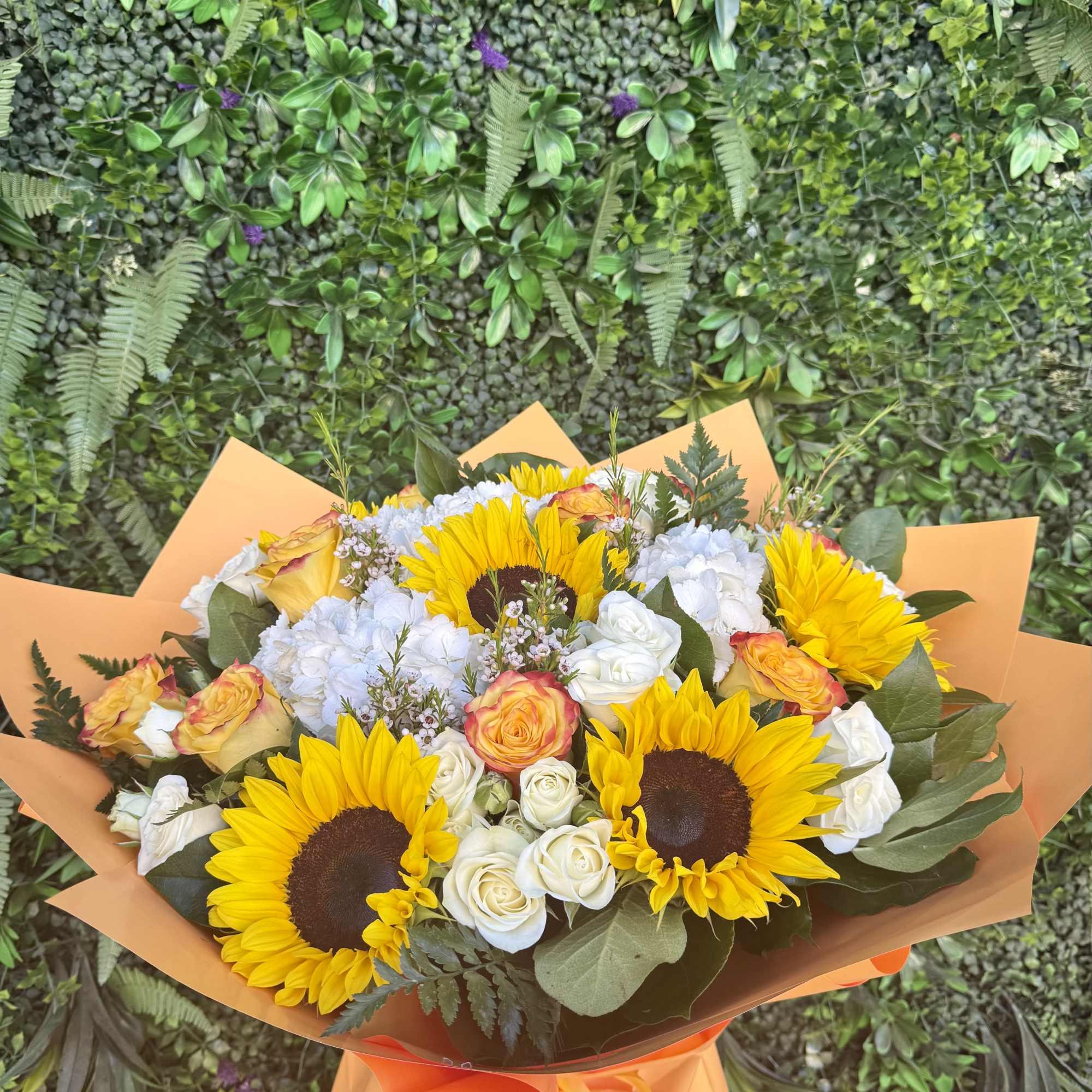 A bright and joyful bouquet featuring sunflowers, symbolizing warmth, positivity, and happiness.