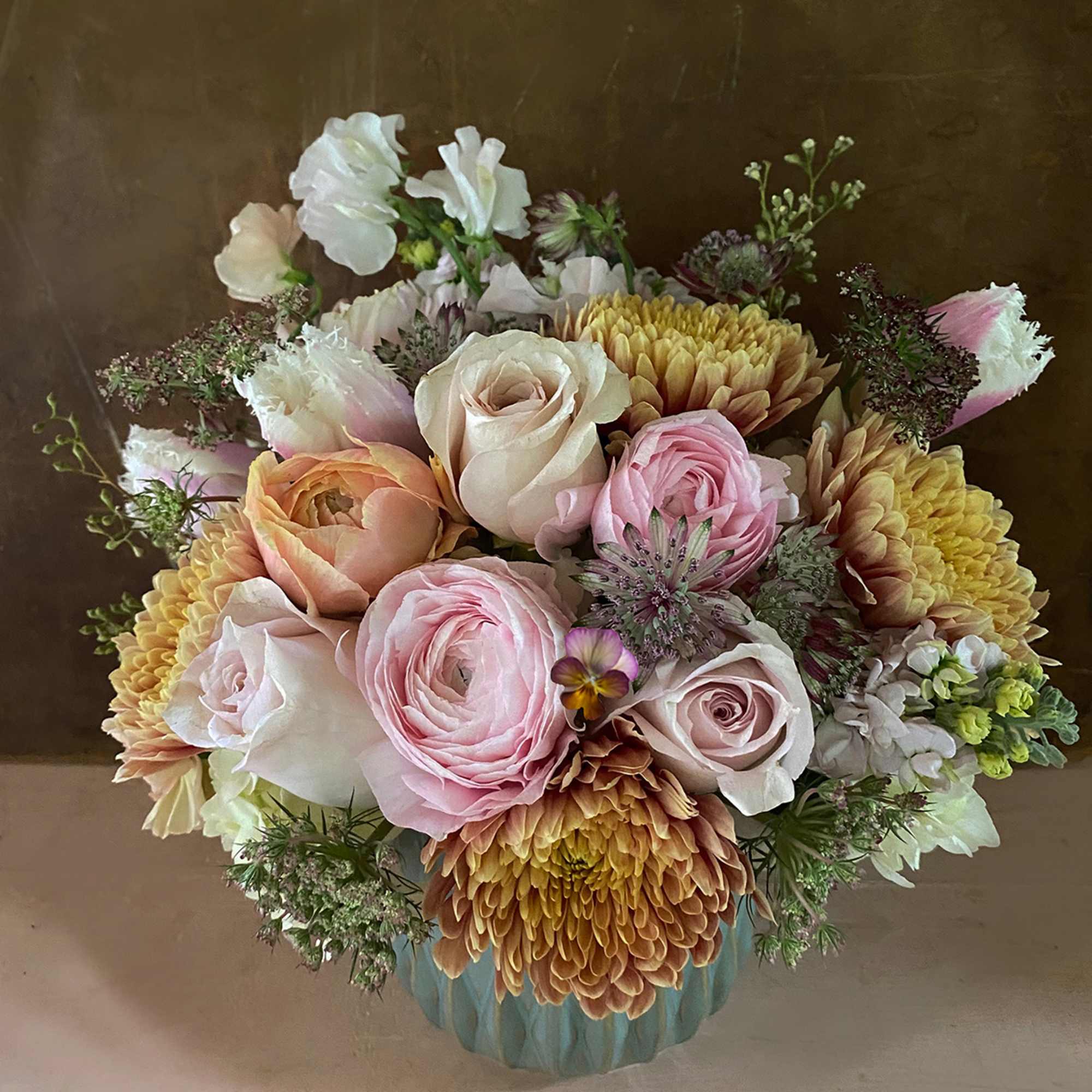 Make someone happy with the stylish arrangement of golden, dusty, blush colors