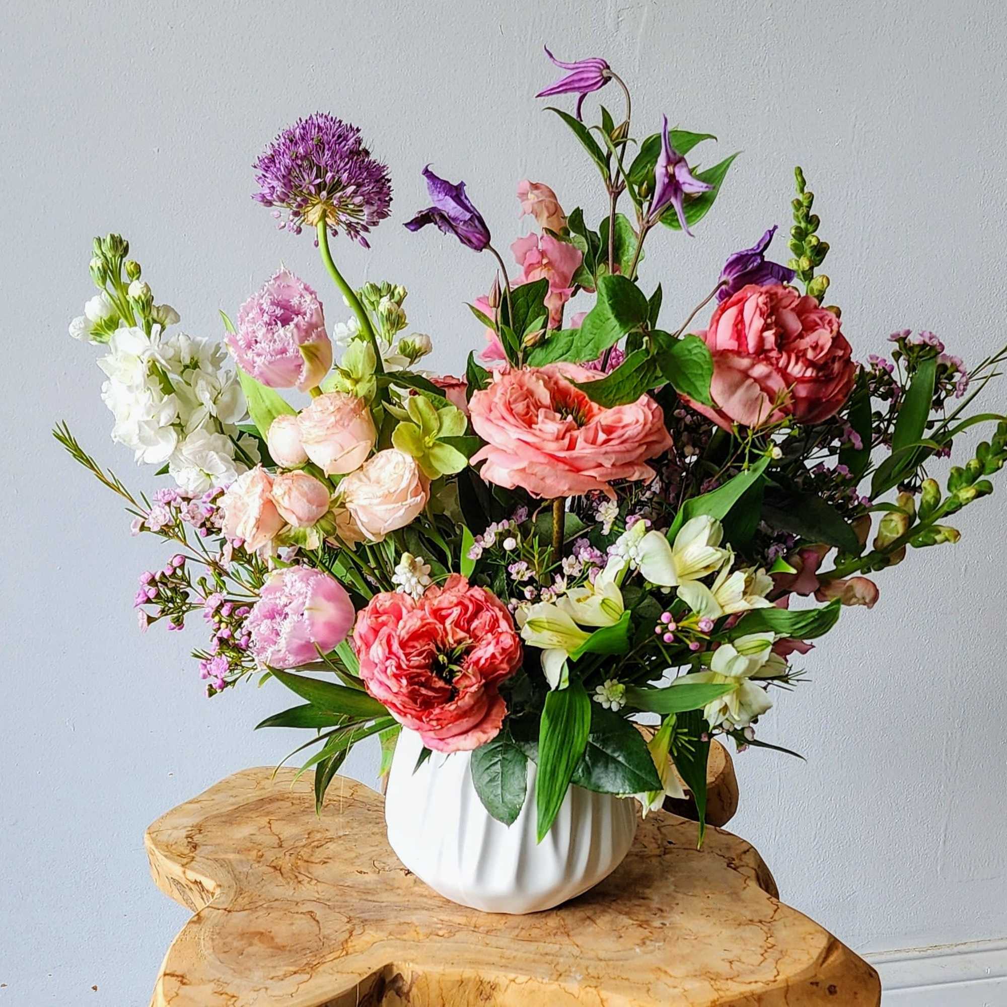 A lush, garden-inspired design filled with soft spring blooms in a romantic