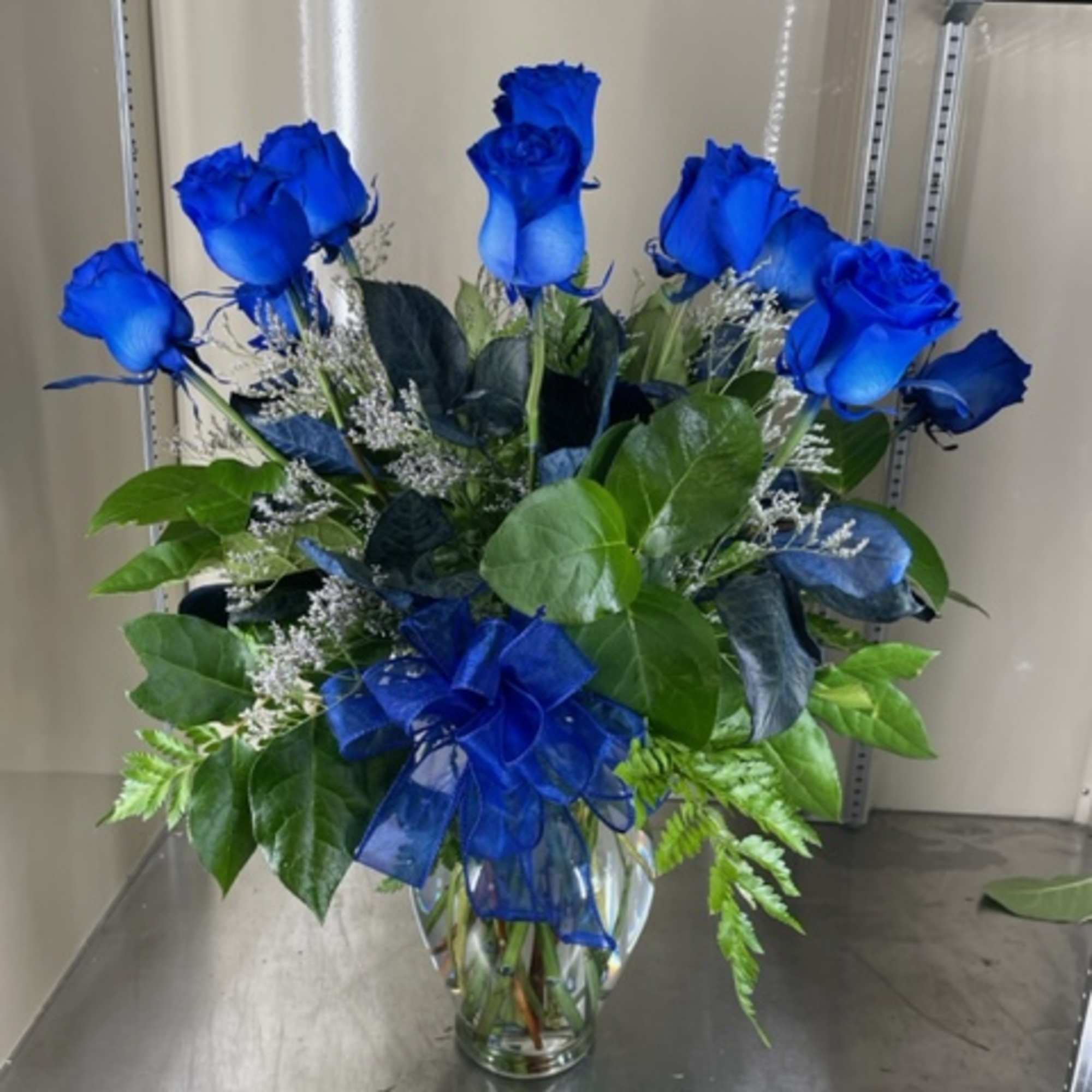 12 dyed blue roses in vase with misty blue accent