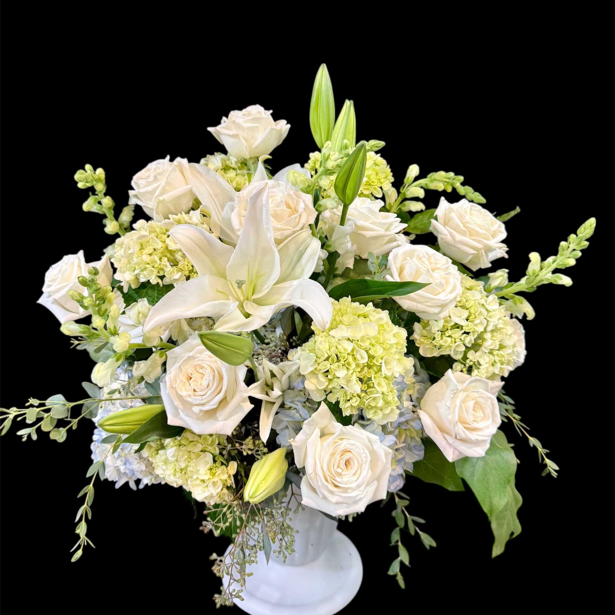 A Beautiful floor basket filled with pure white flowers,
designed to bring peace