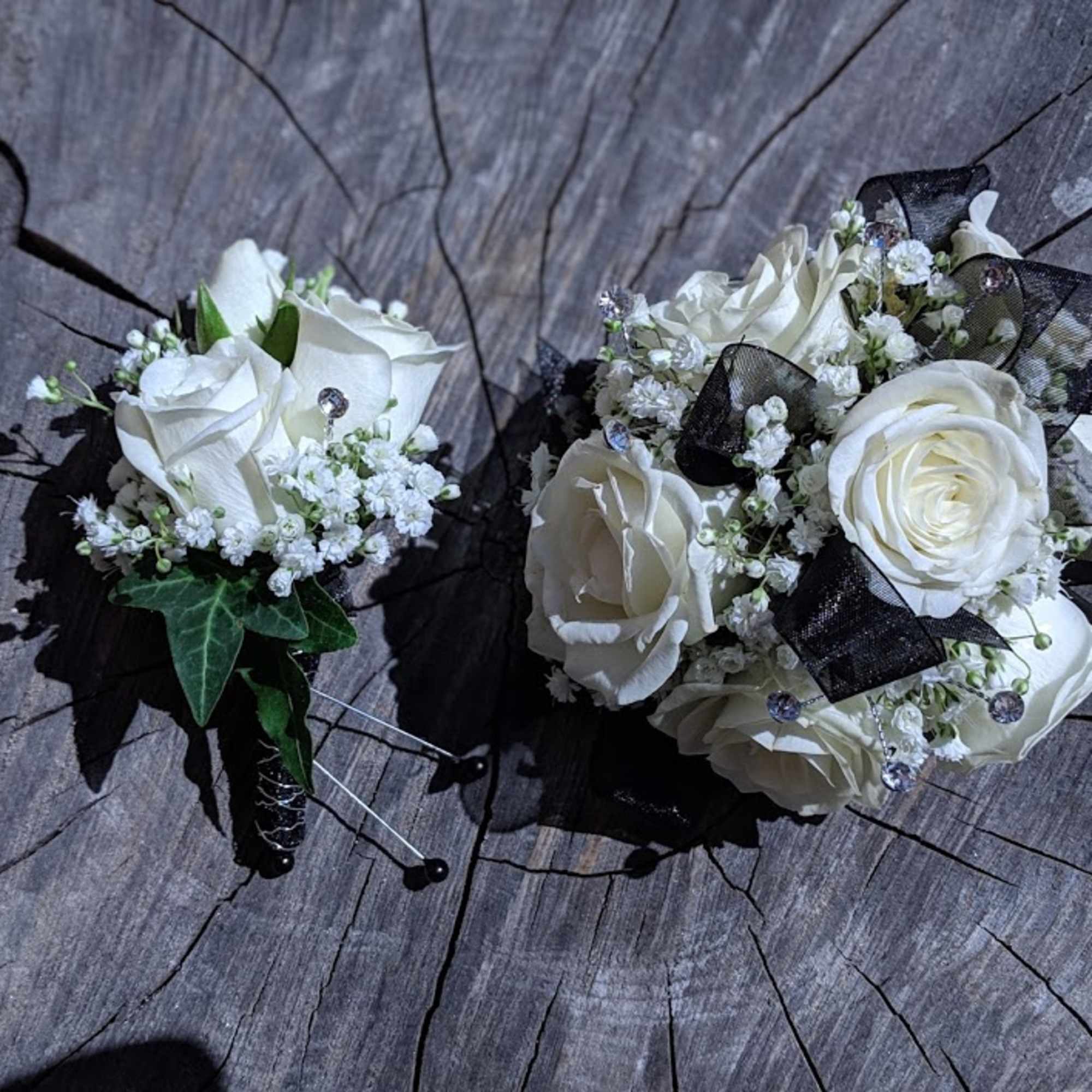 Shown as Standard
White spray roses, babies breath, gems and black ribbon come