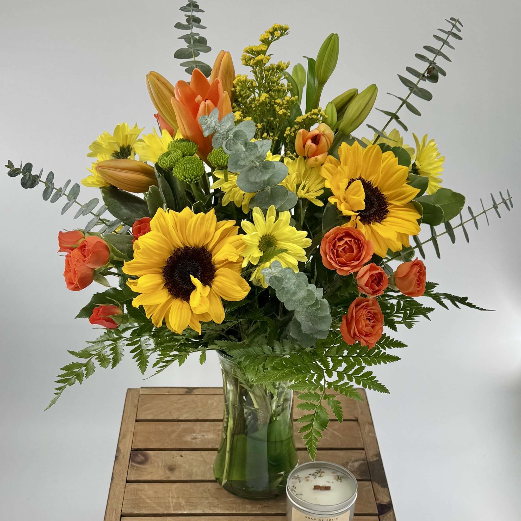 Celebrate autumn with this beautiful floral arrangement of vibrant orange lilies, soft