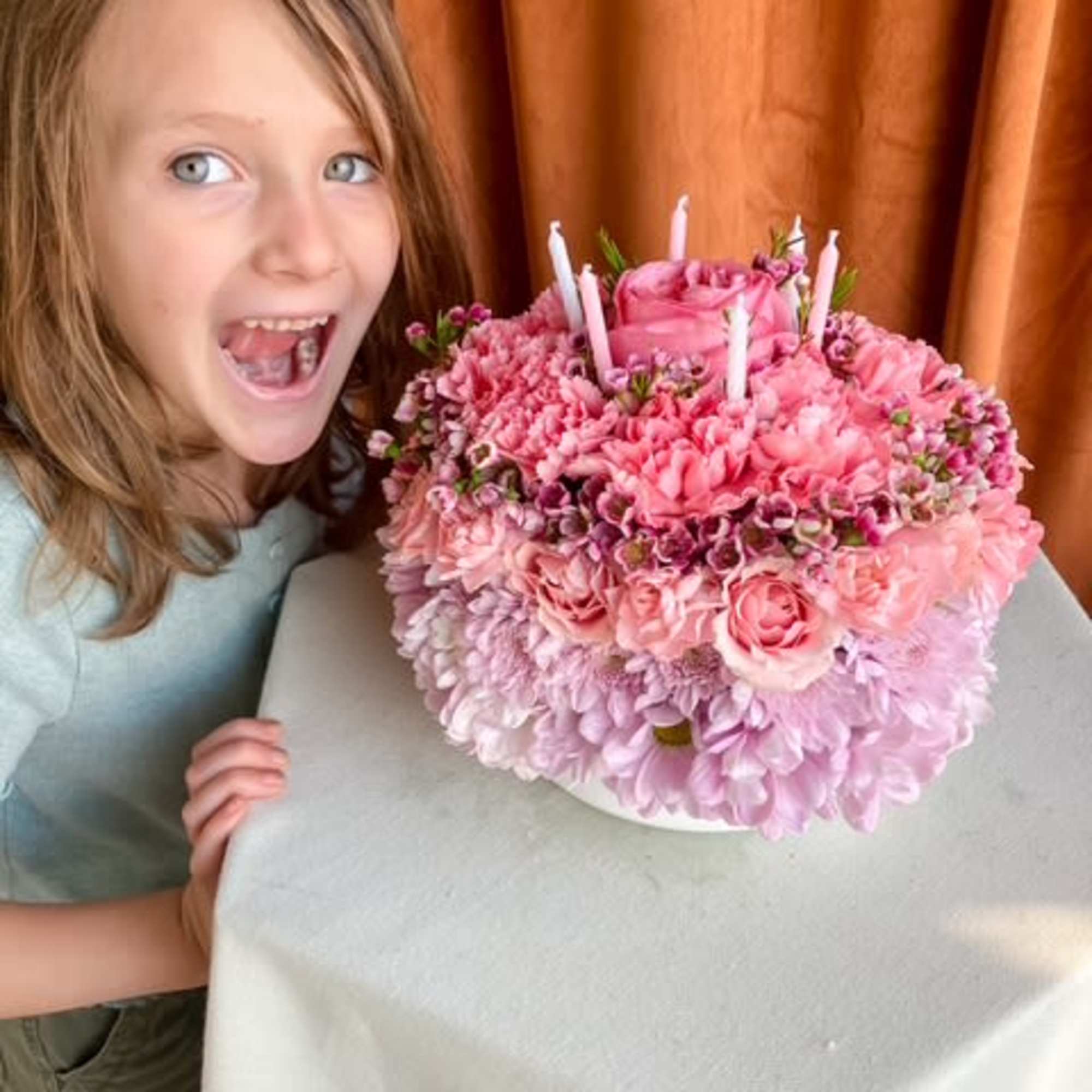 Our Birthday Bloom Cake is a lush, garden-inspired floral arrangement designed to