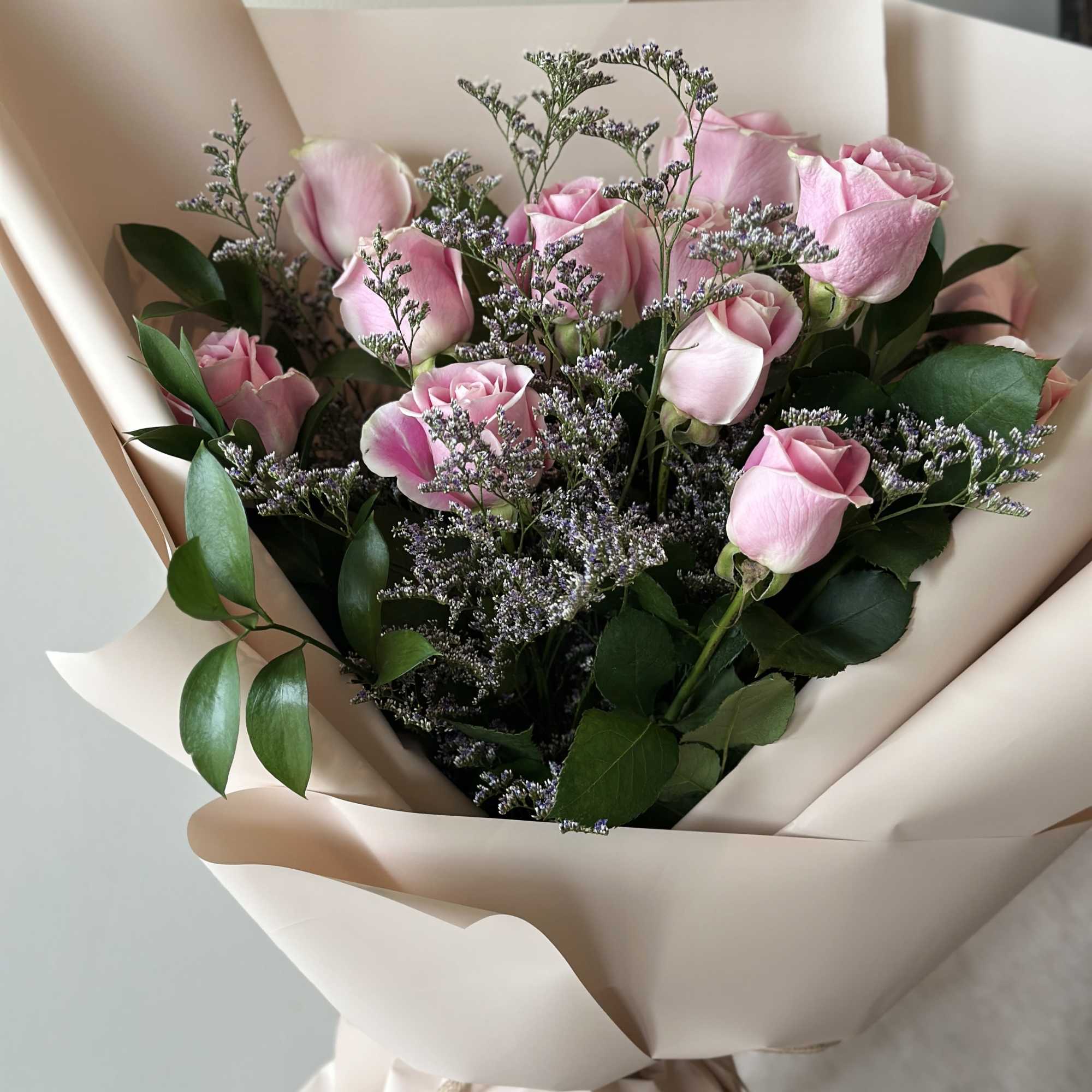 12 pink roses in a hand bouquet