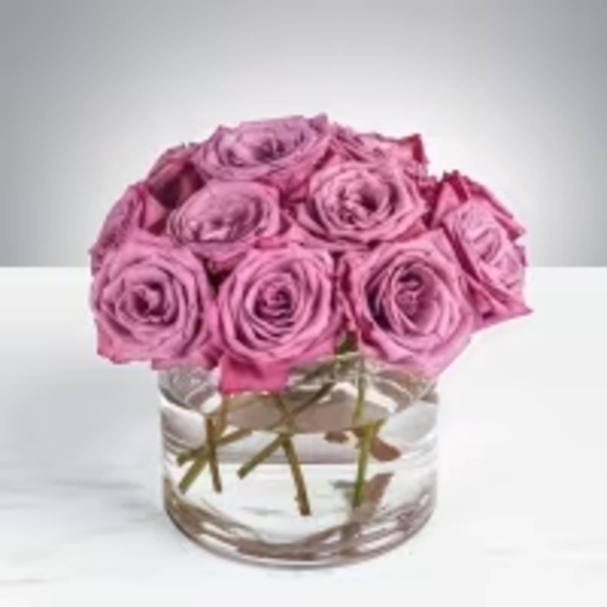 Lavender-pink roses gathered into a soft, compact dome give this arrangement a