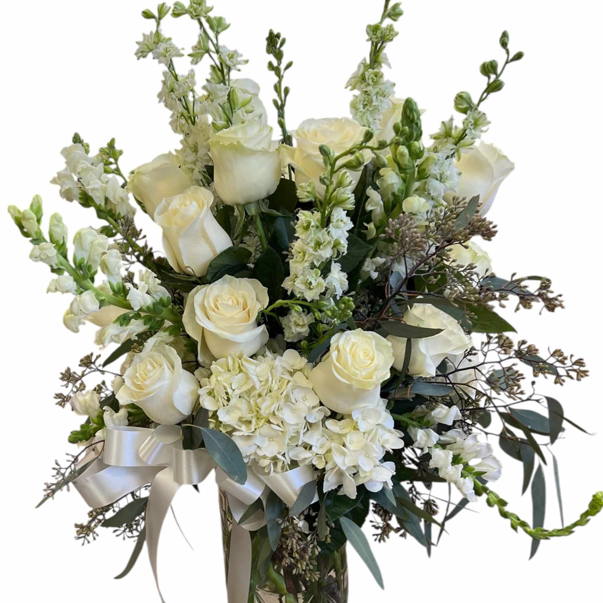 This timeless all-white arrangement brings a sense of serenity and respect, making