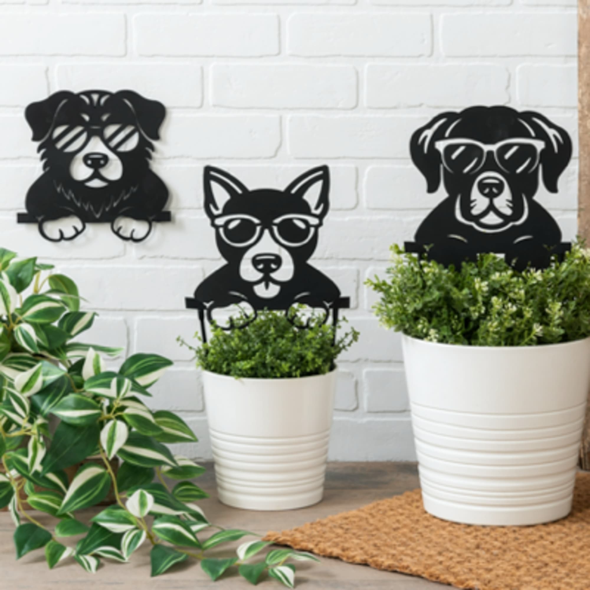 White potted plants with black dog-shaped stakes wearing sunglasses against a white brick wall