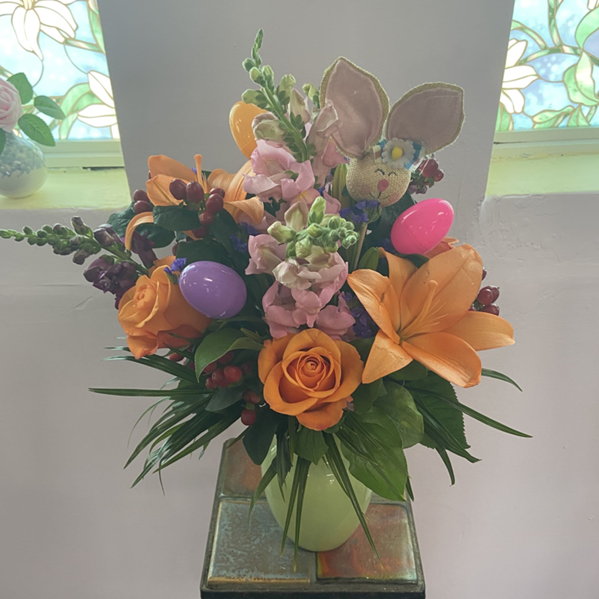Hop into Spring with this adorable Easter Arrangement! A festive pastel green
