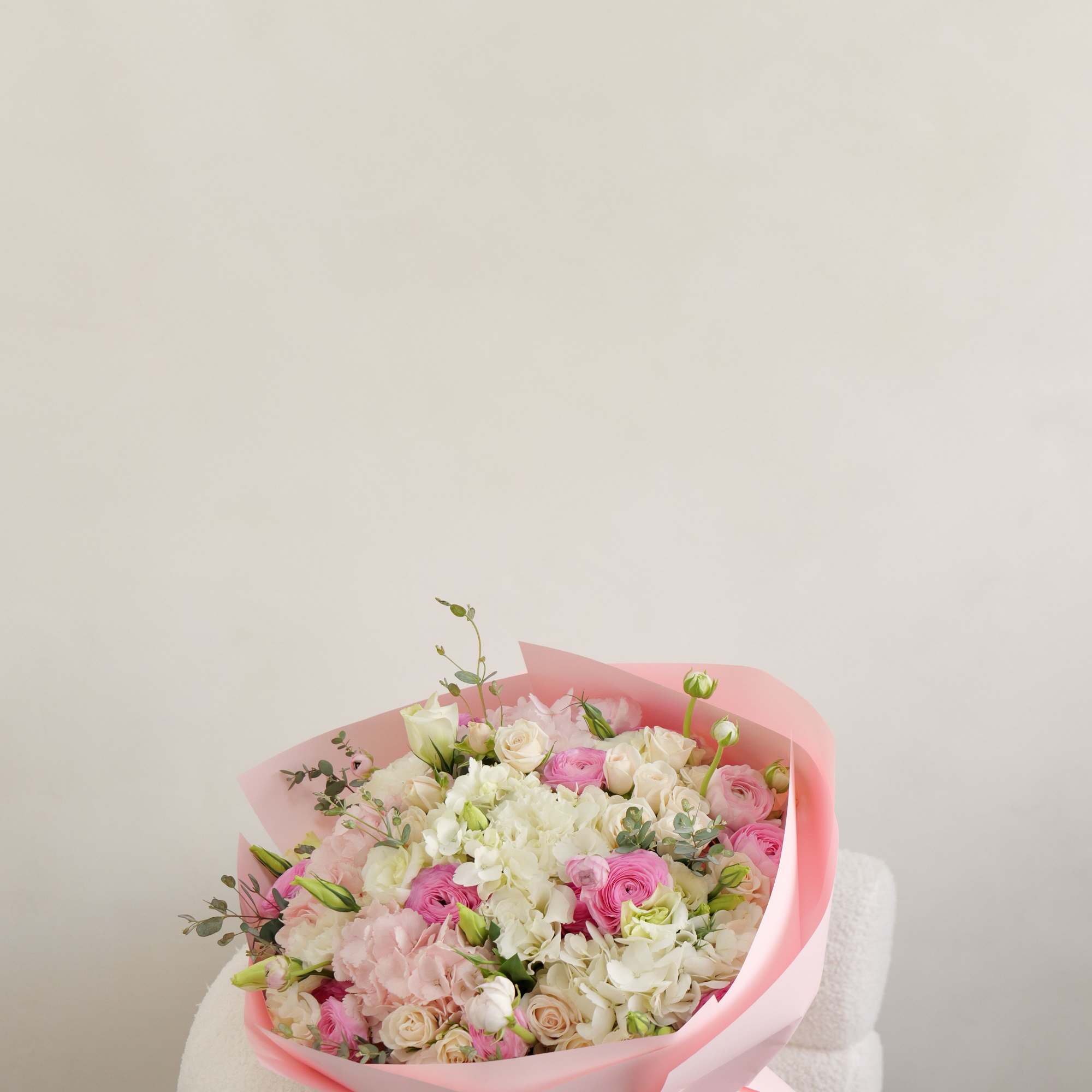 A dreamy bouquet filled with soft pink blooms and fresh seasonal flowers