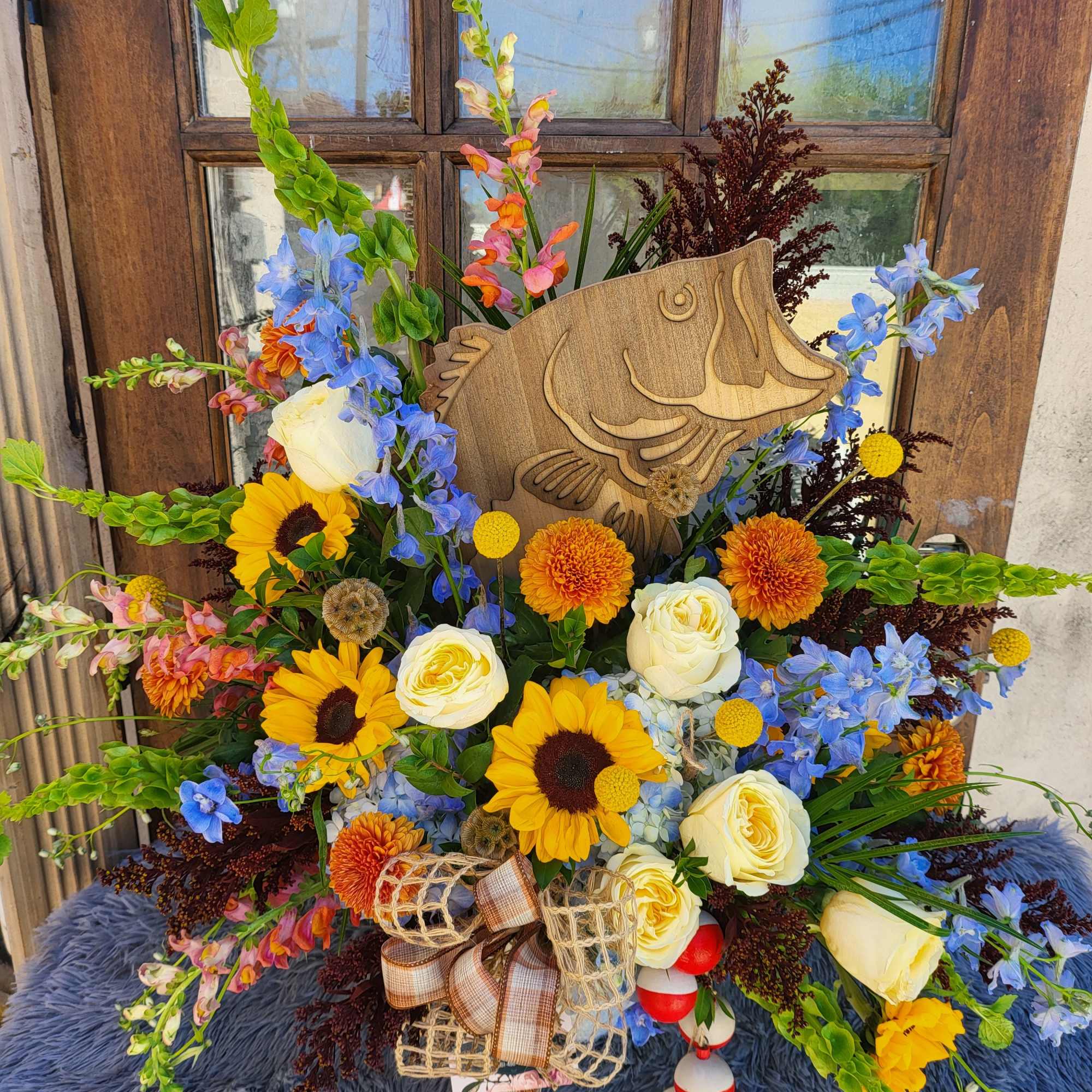 A beautiful collection of garden flowers &amp; a wooden Bass Fish just