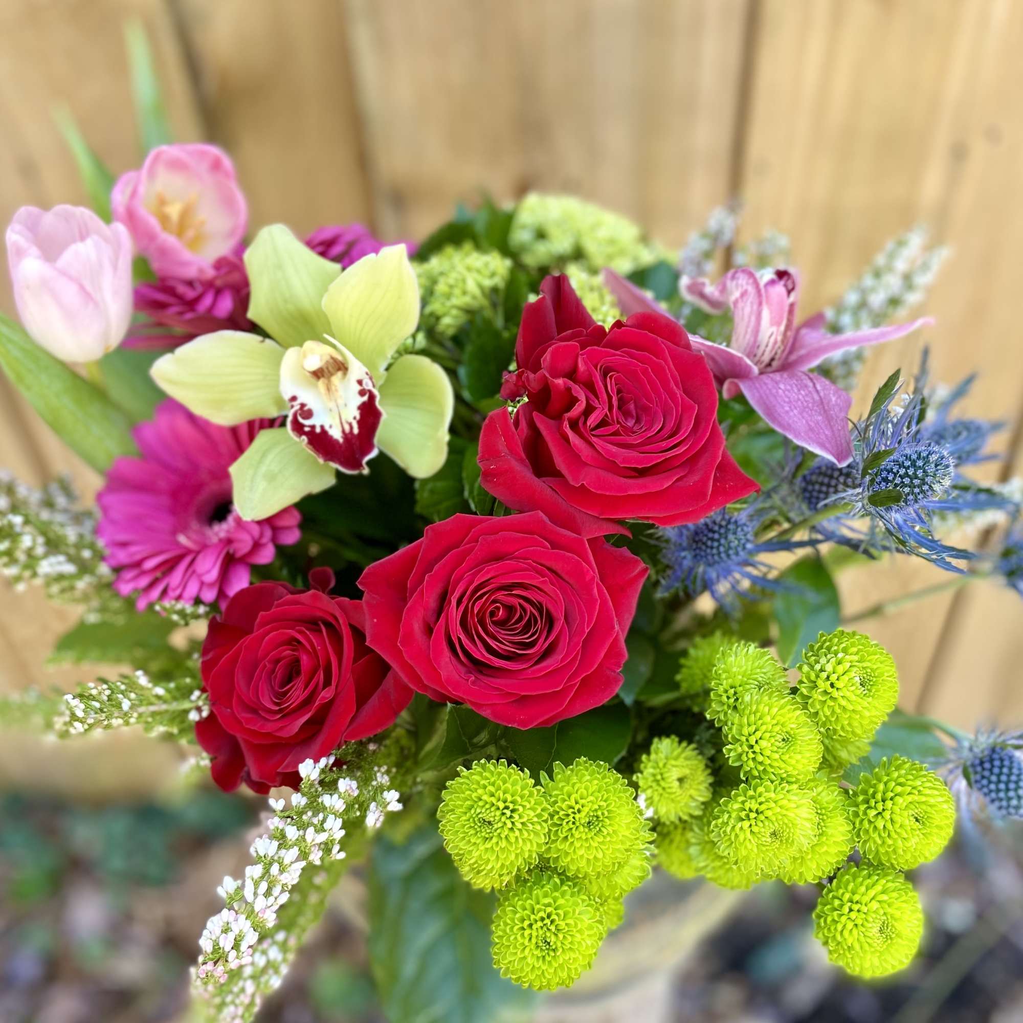 A collection of Red Roses, pink Tulips, Green Hydrangea, Hot Pink Daisys