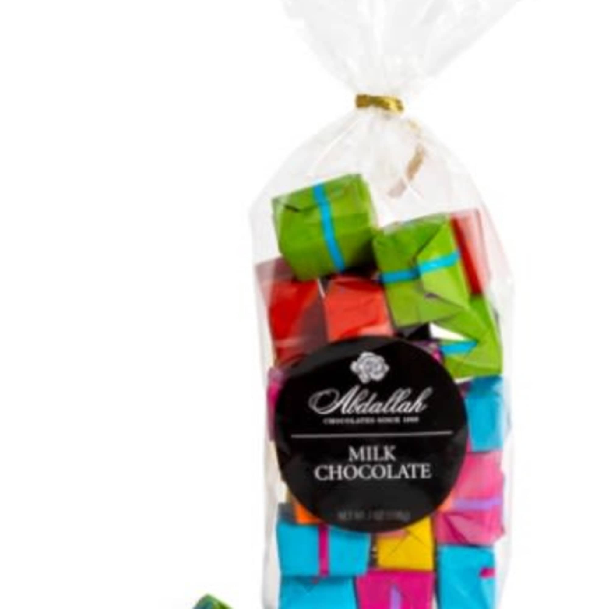 Bag of assorted milk chocolates in bright foil wrappers with a black circular label