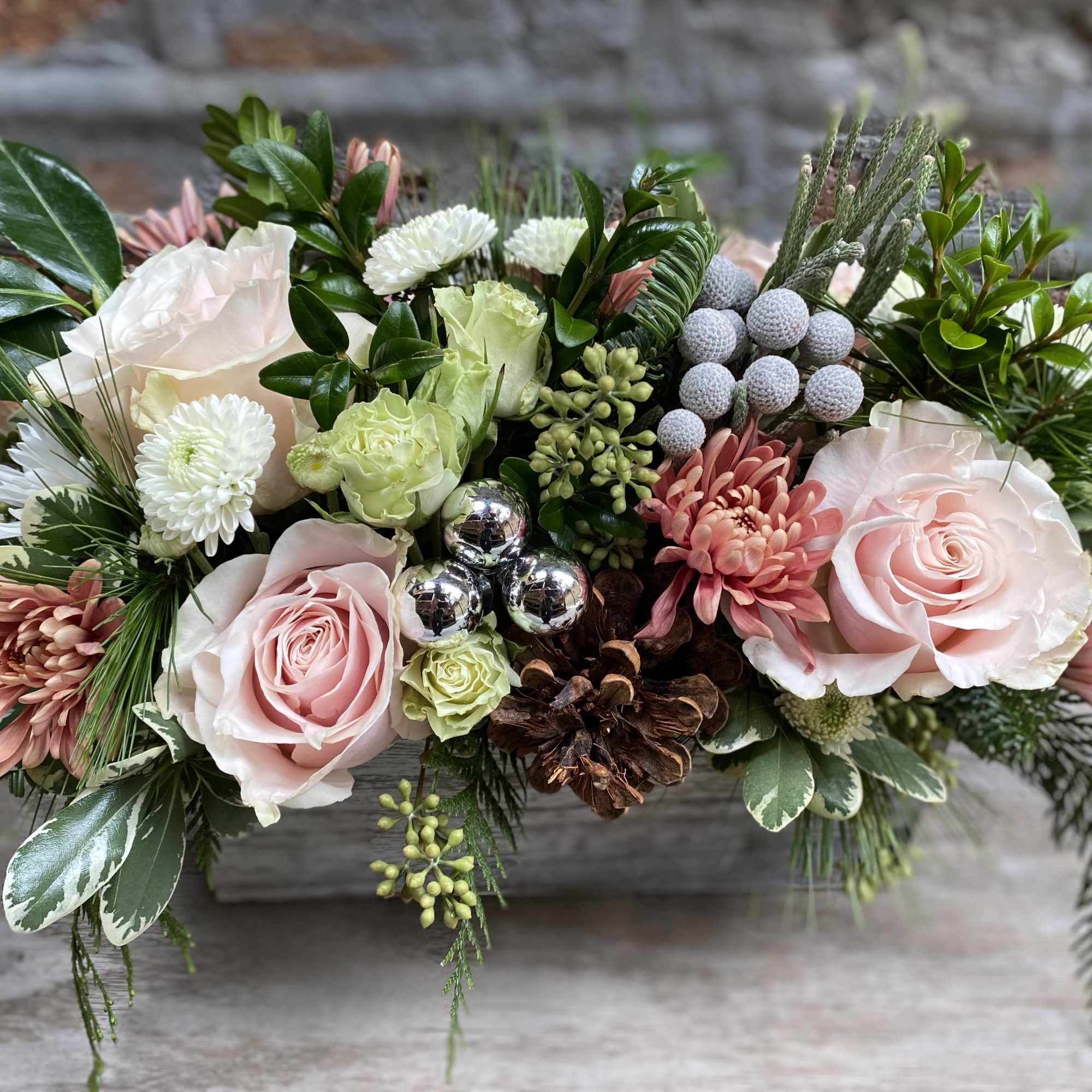 Low floral arrangement with pale pink roses and white blooms