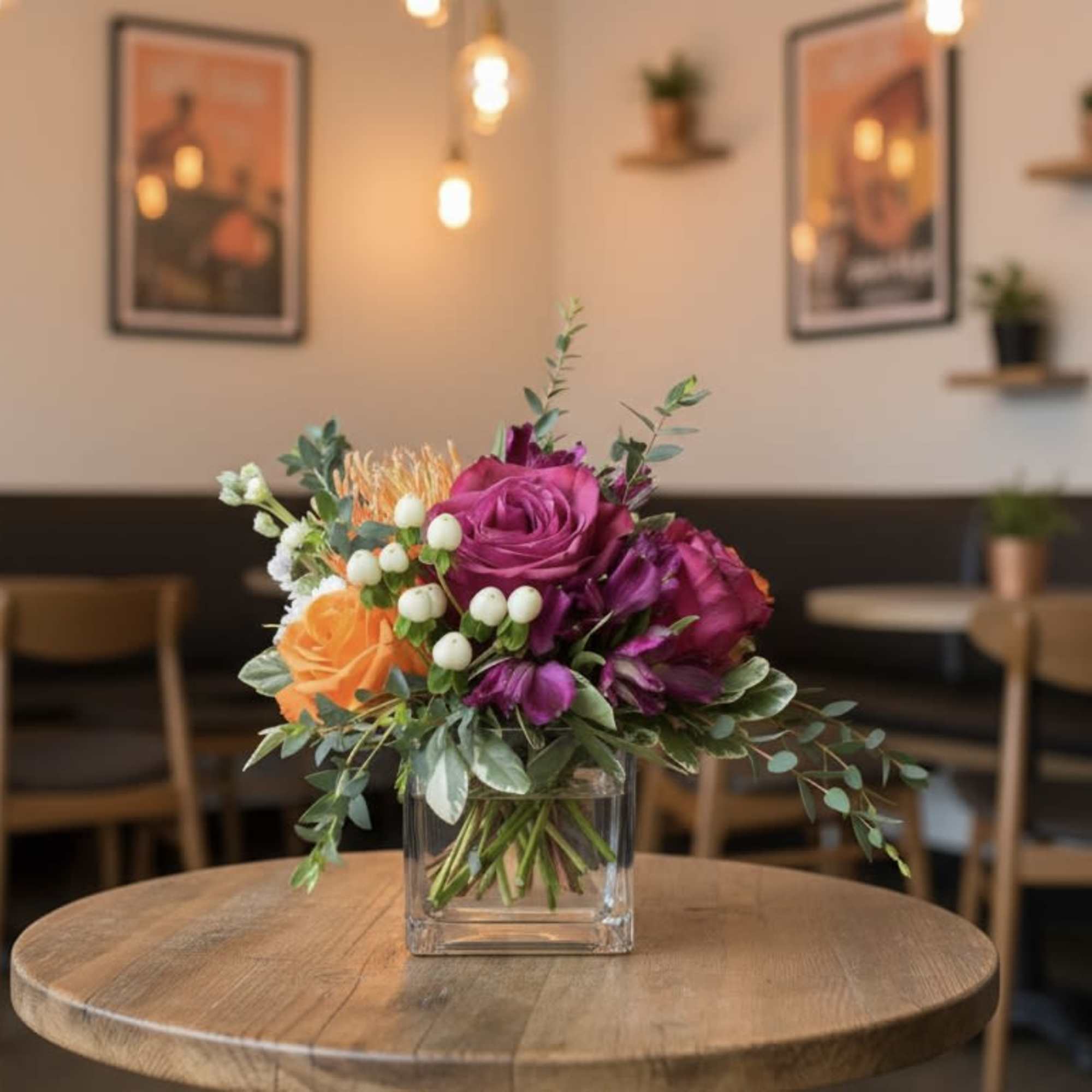Low Arrangement in a Clear Glass Cube of jewel tone roses, pin