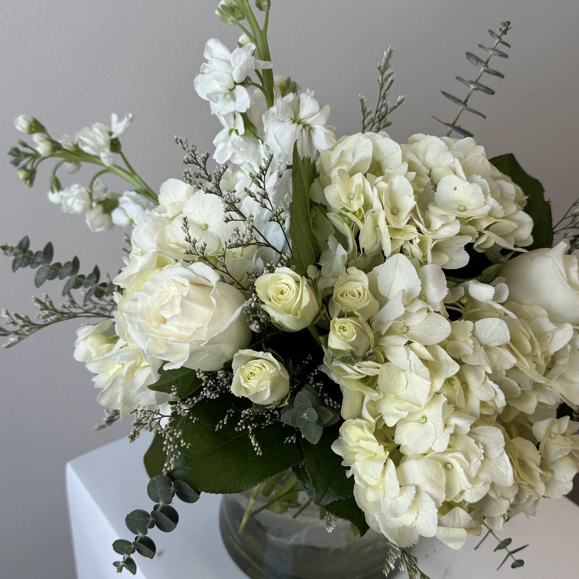 White floral bouquet in a clear glass vase