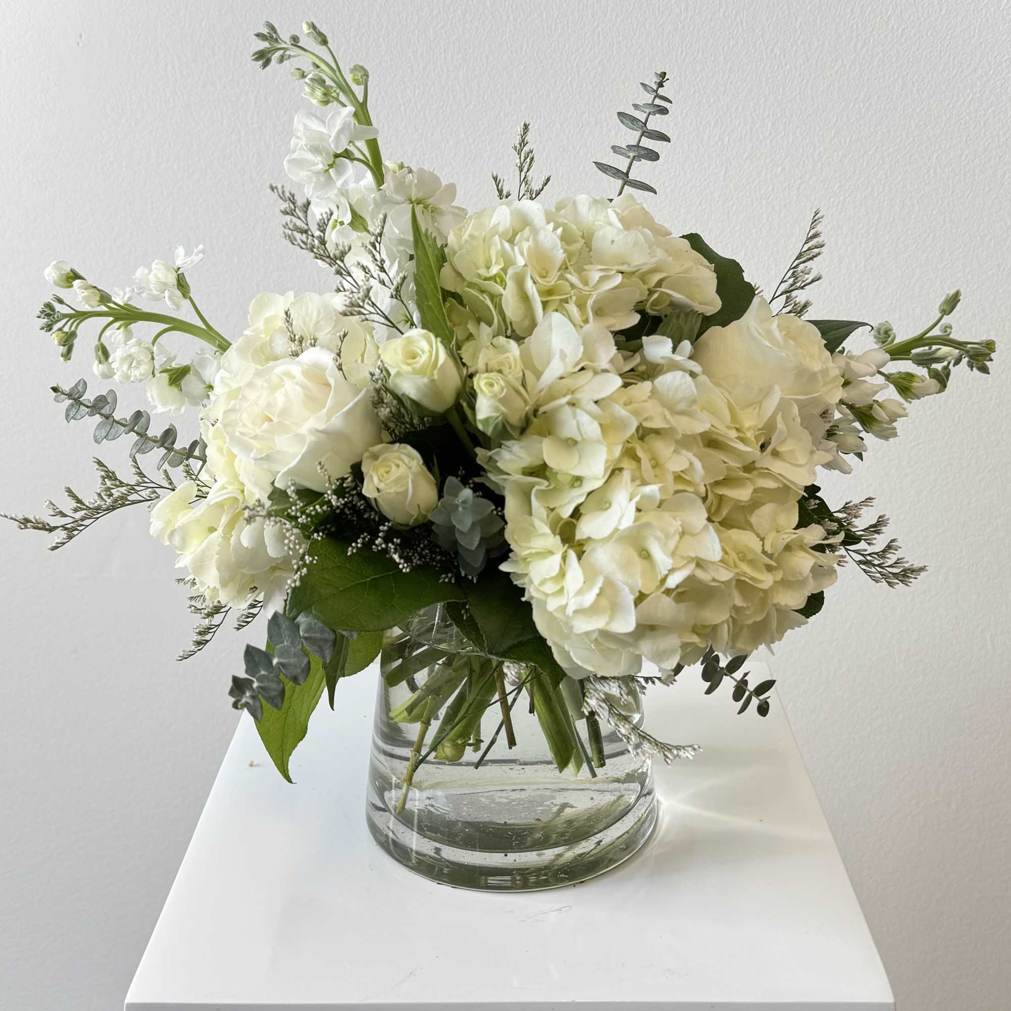 White floral bouquet in a clear glass vase