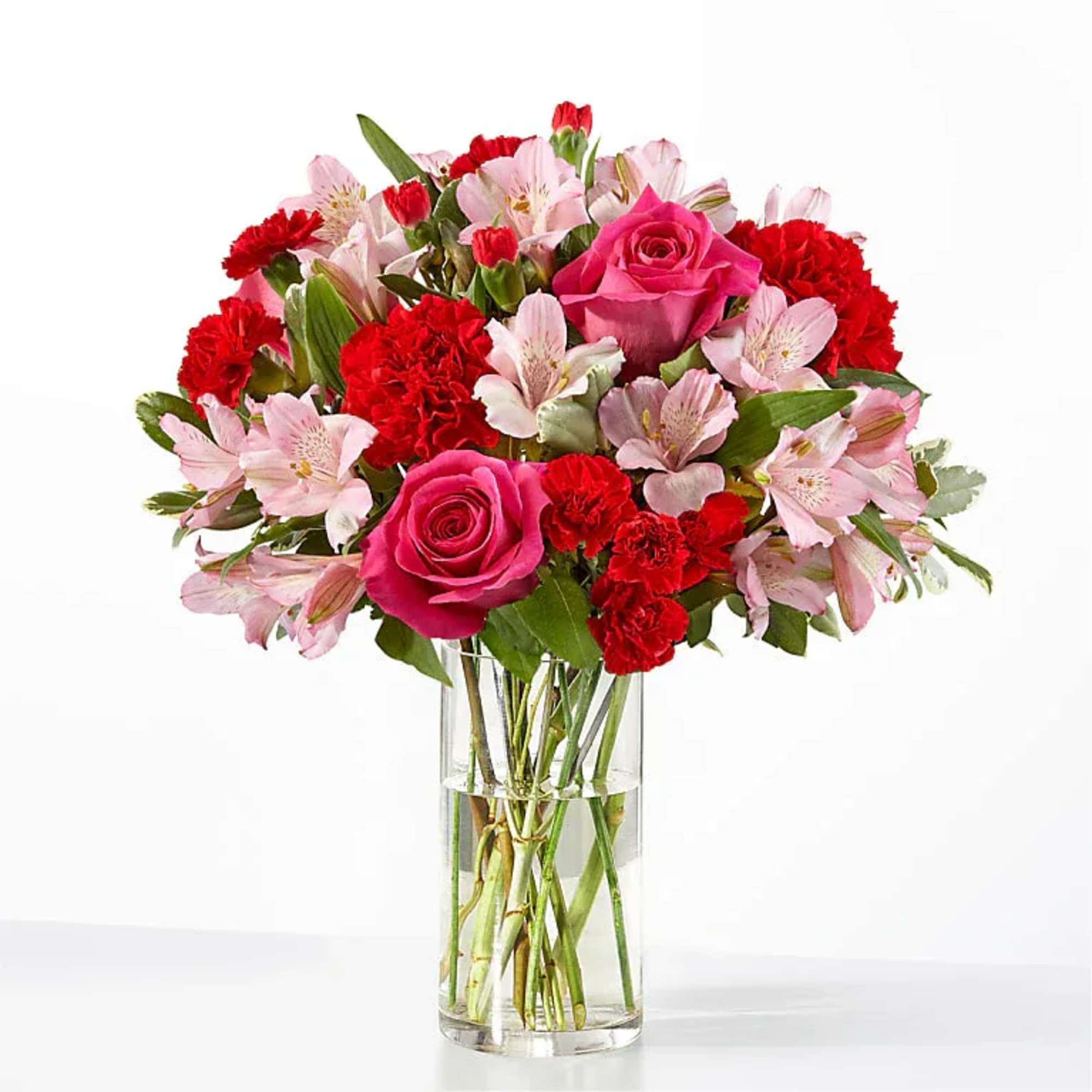 Blushing shades of pink blooms are nestled in lush greens to charm