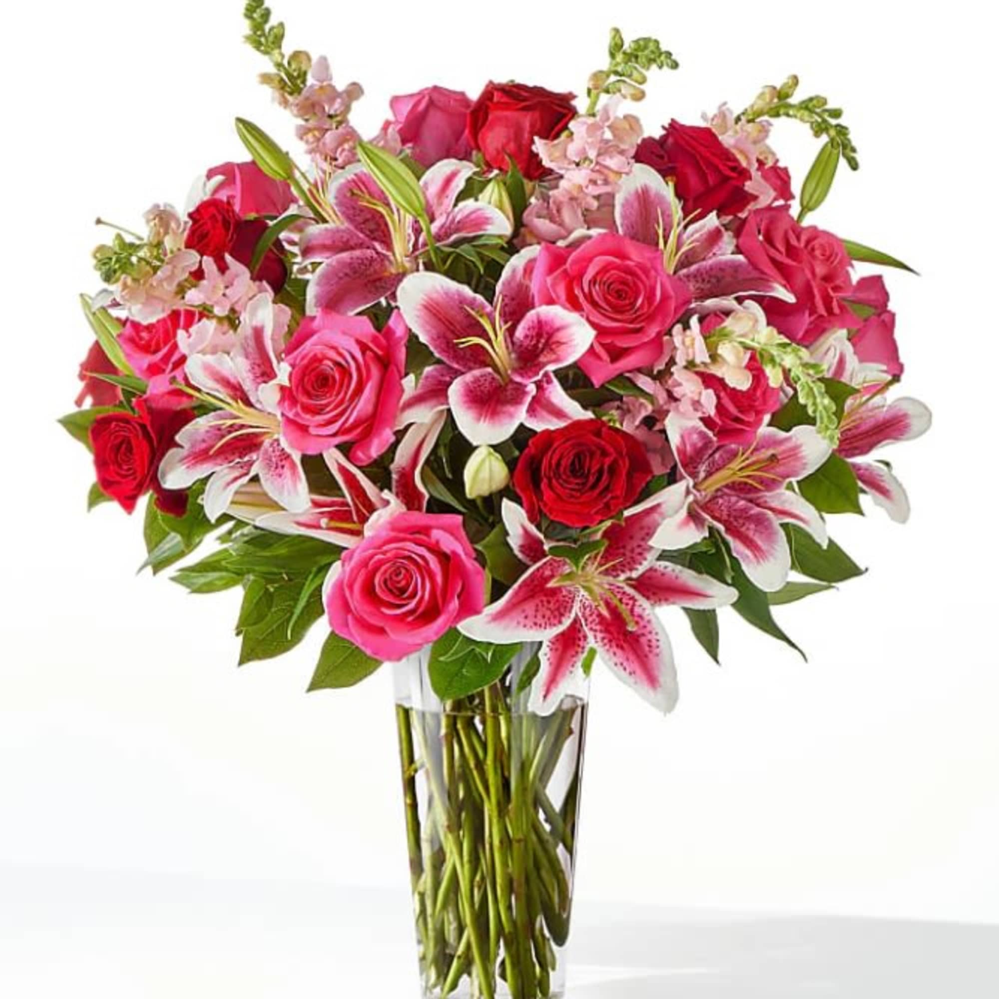 A luxurious and decadent design of roses, lilies, and snapdragons that will
