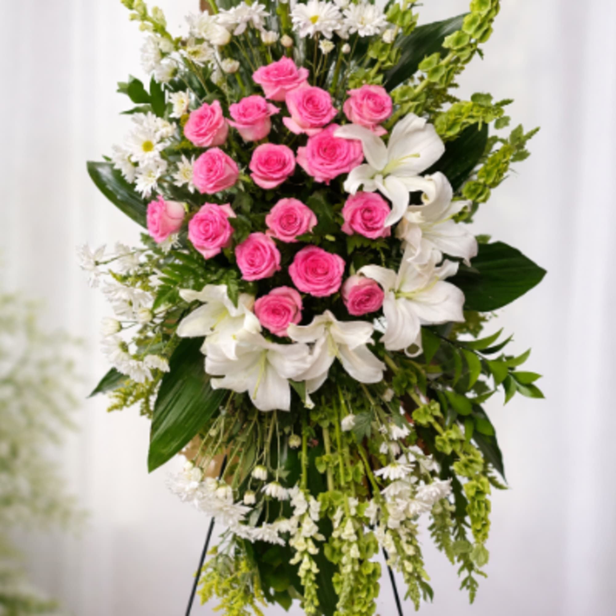 A sculptural standing spray that speaks with quiet dignity-this flower arrangement is