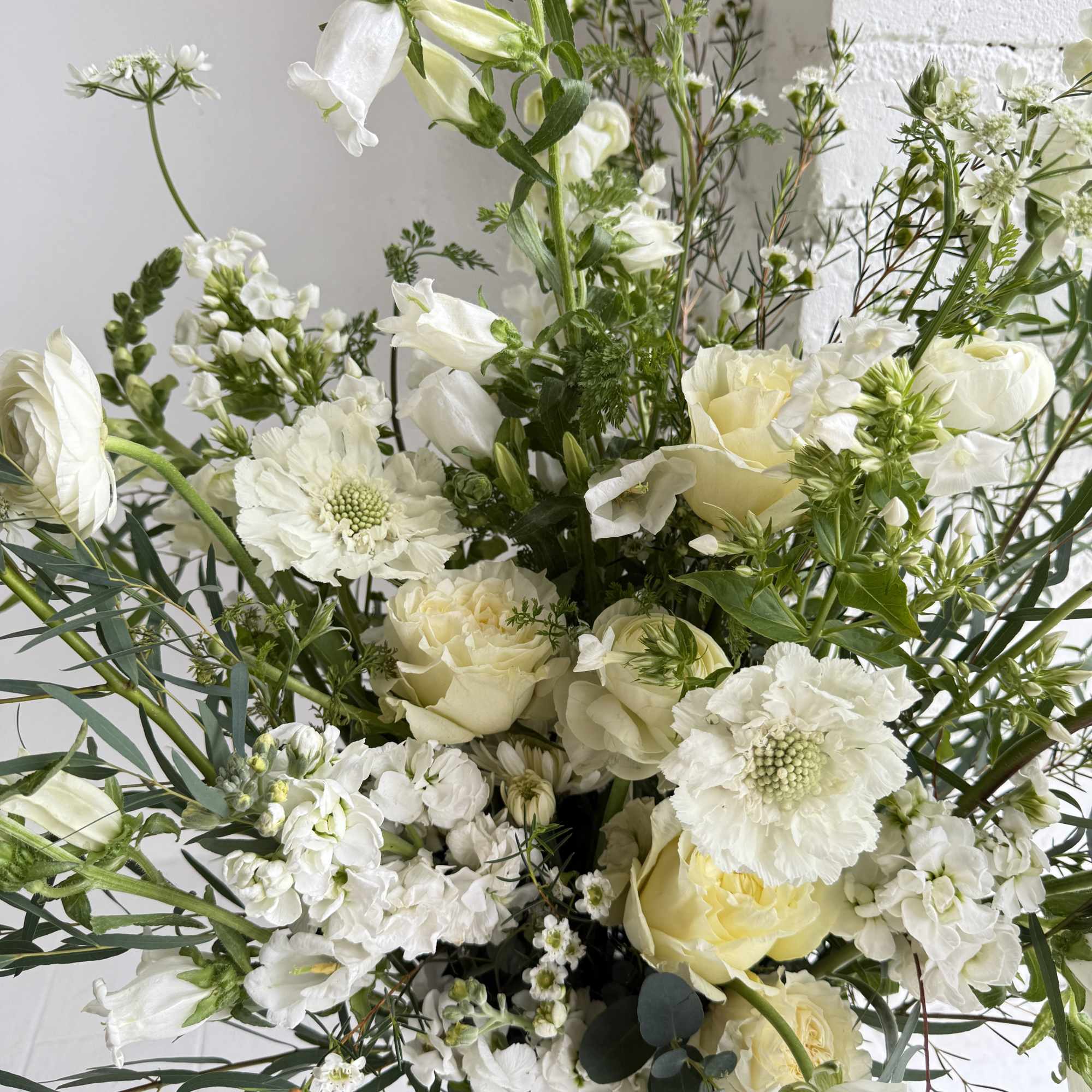 This arrangement is a large scale blooming wonderland. We favor flowers with