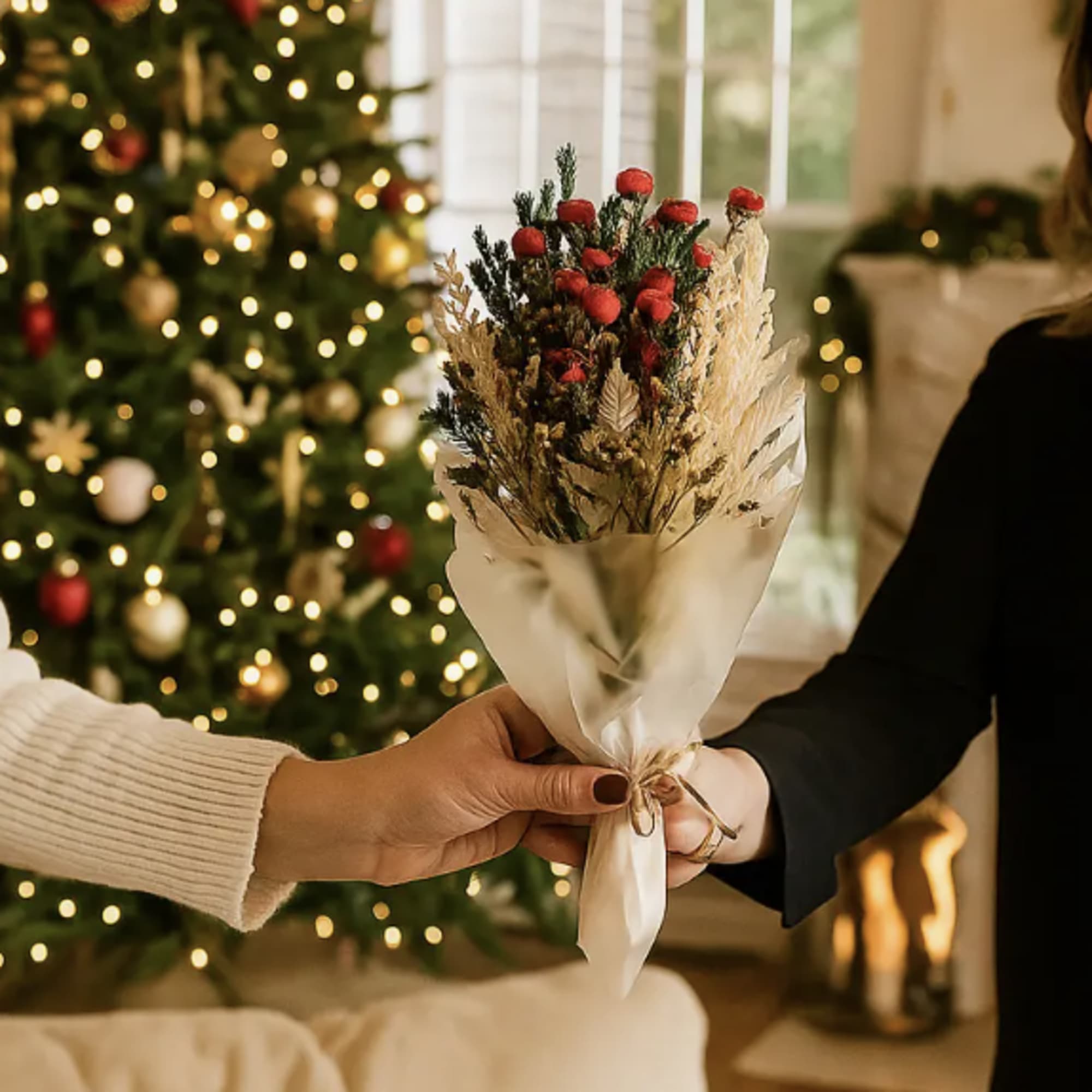 Small bouquet of red dried flowers wrapped in white paper