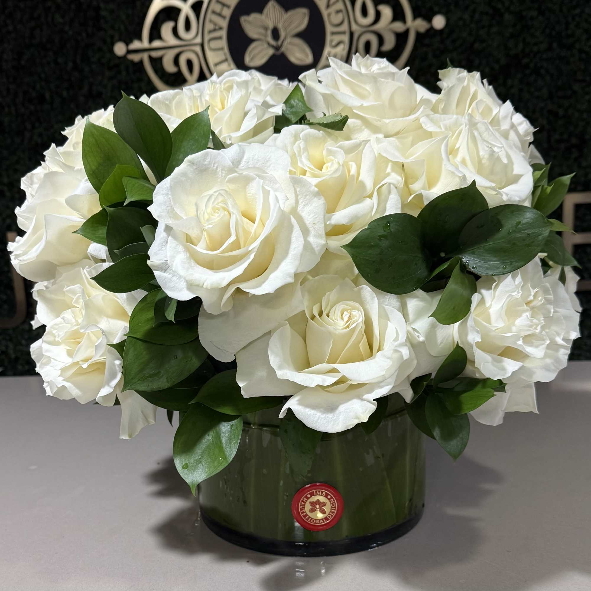 Premium rose low arrangement in leaf lined vase, perfect for centerpiece or