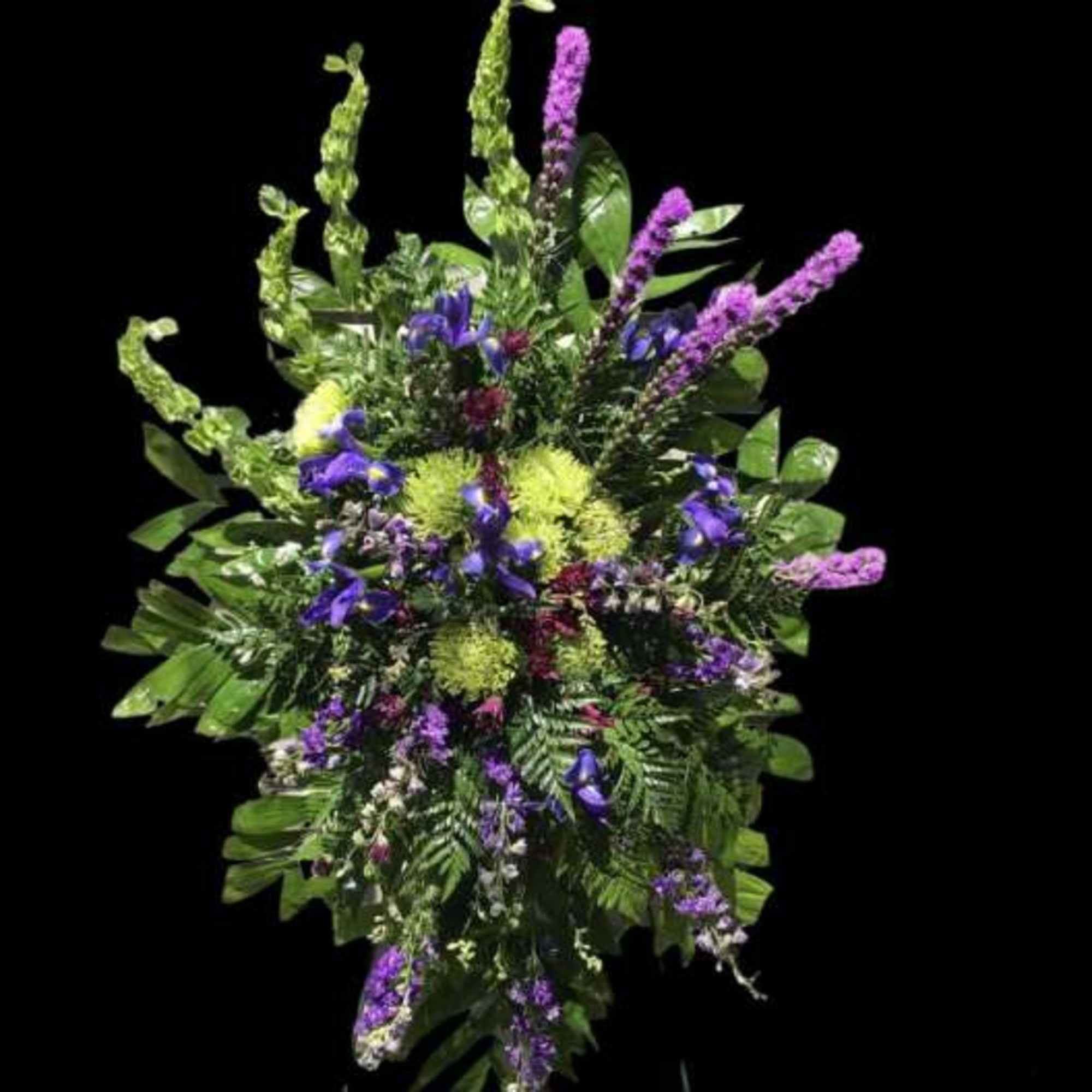 Tall spray of purple and green flowers in a lush fan-shaped arrangement