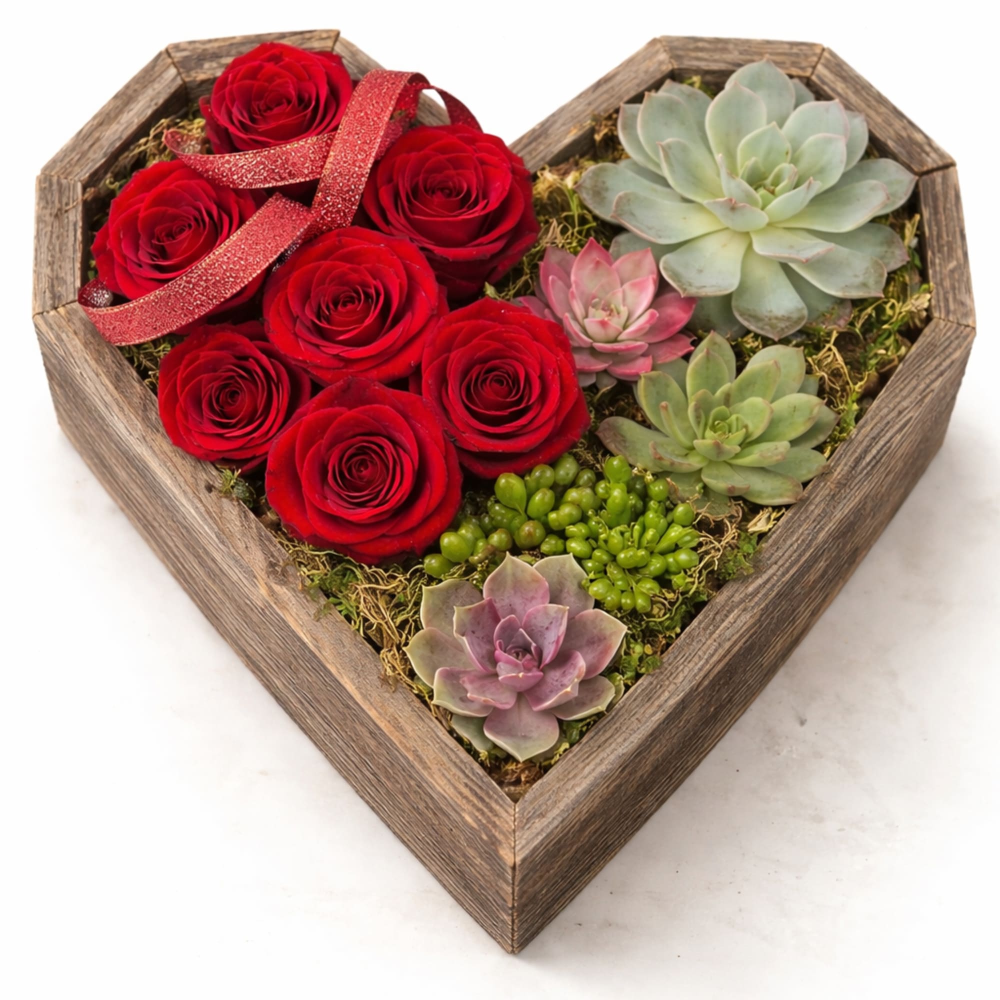 Heart-shaped wooden box filled with red roses and assorted succulents.