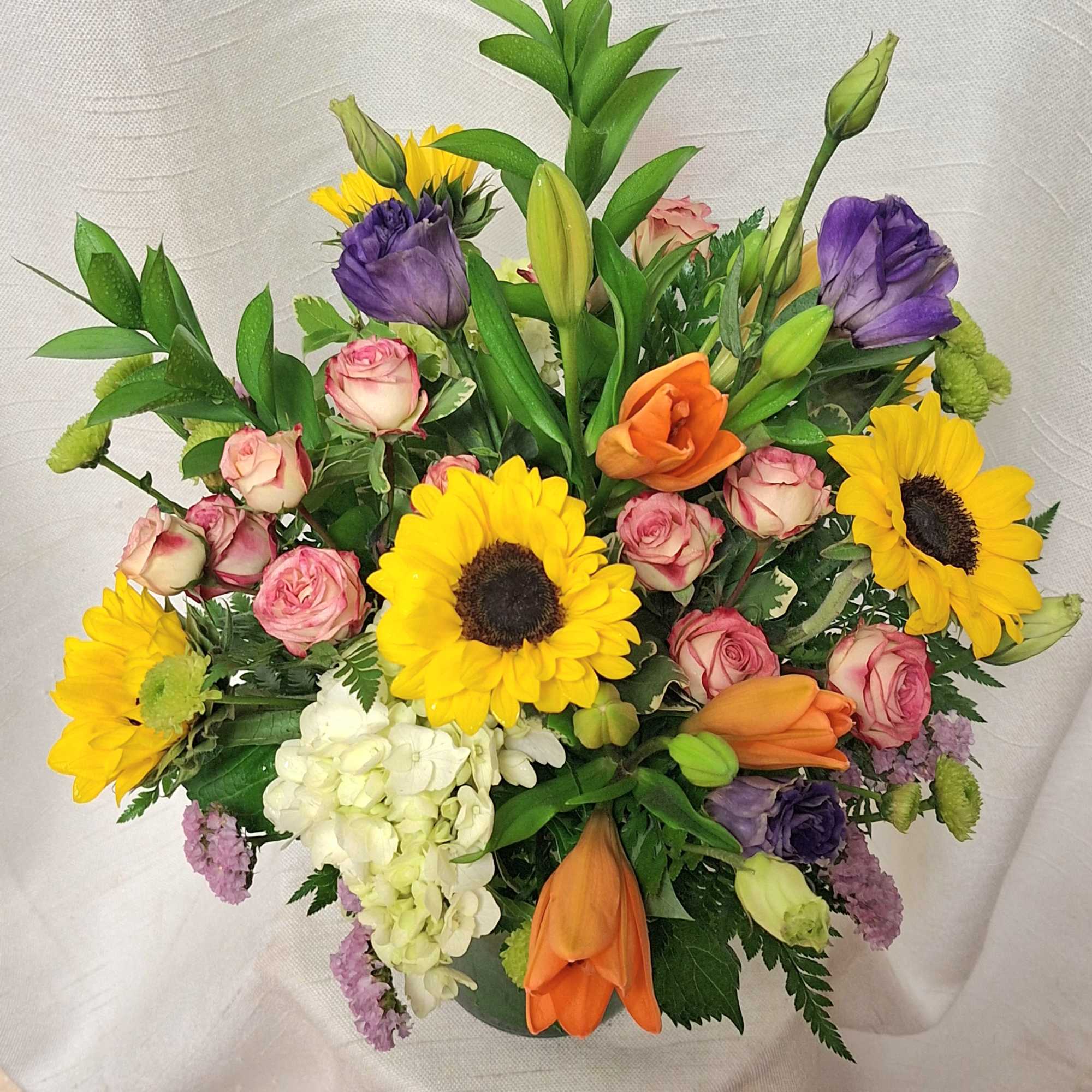 Indulge in the modern charm of our vibrant flower arrangement, elegantly presented