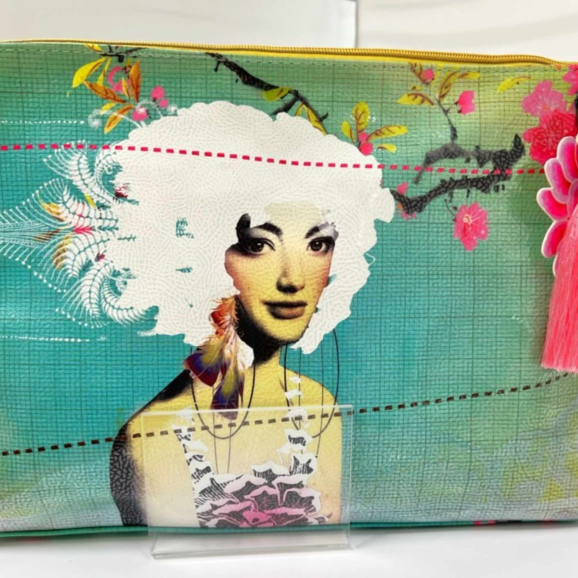 Decorative zip pouch with a portrait print and pink tassel charm