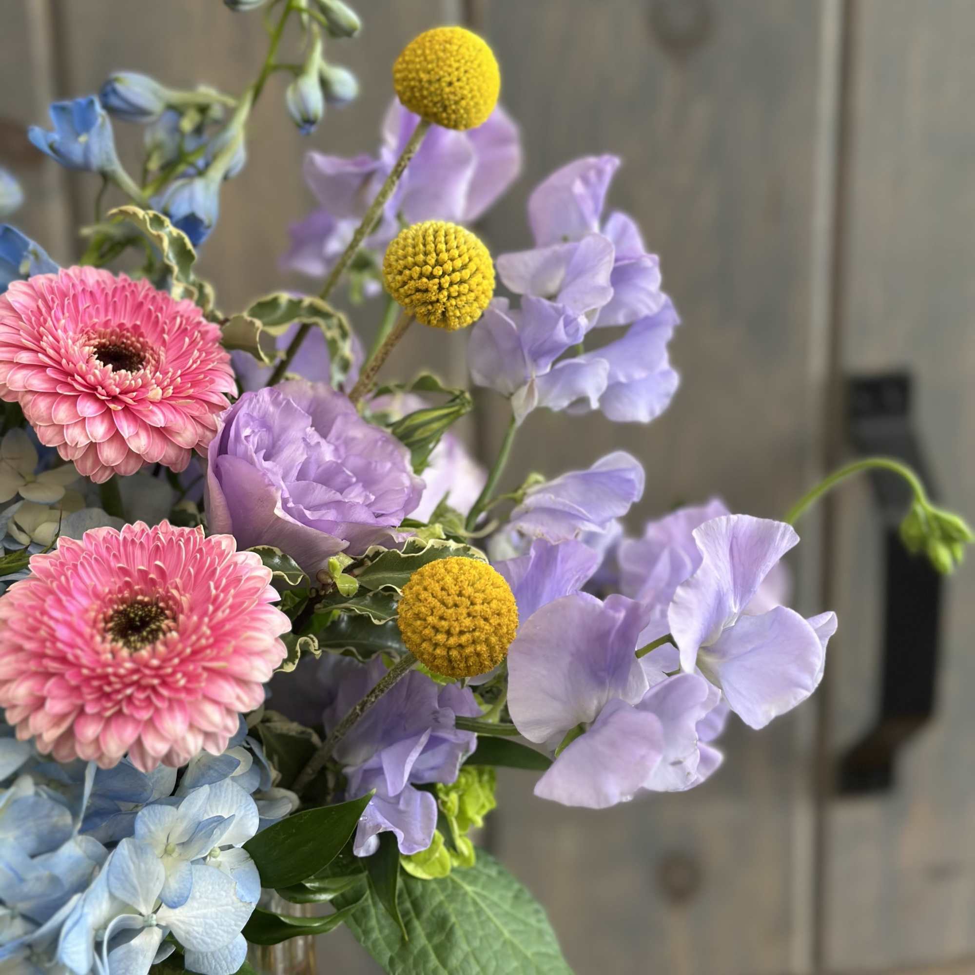 This fun and spring inspired arrangement includes Roses, hydrangea, Mini hydrangea, Sweet