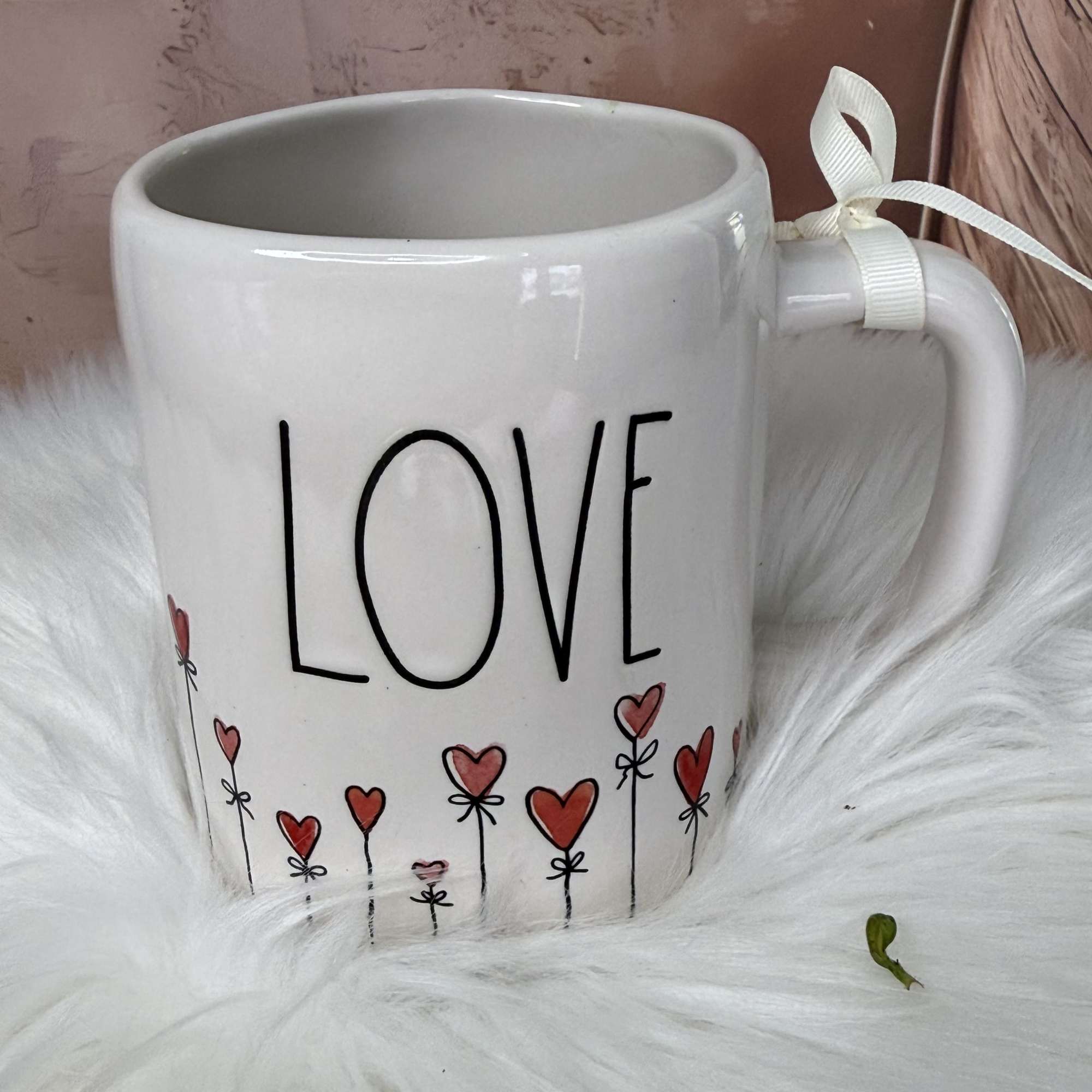  A romantic and delicate floral arrangement presented in a charming LOVE