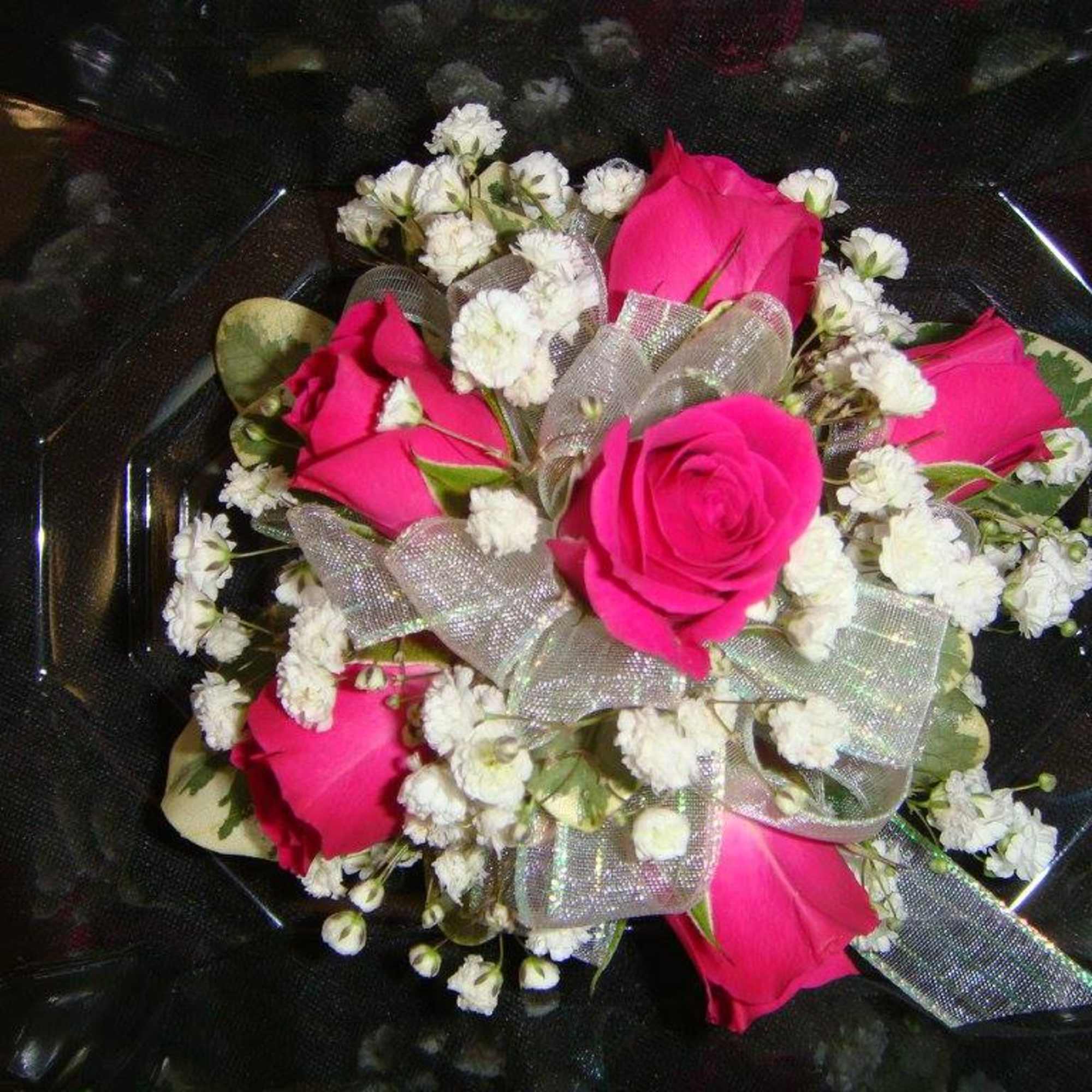 Bouquet of hot pink roses and white baby's breath with a silver ribbon