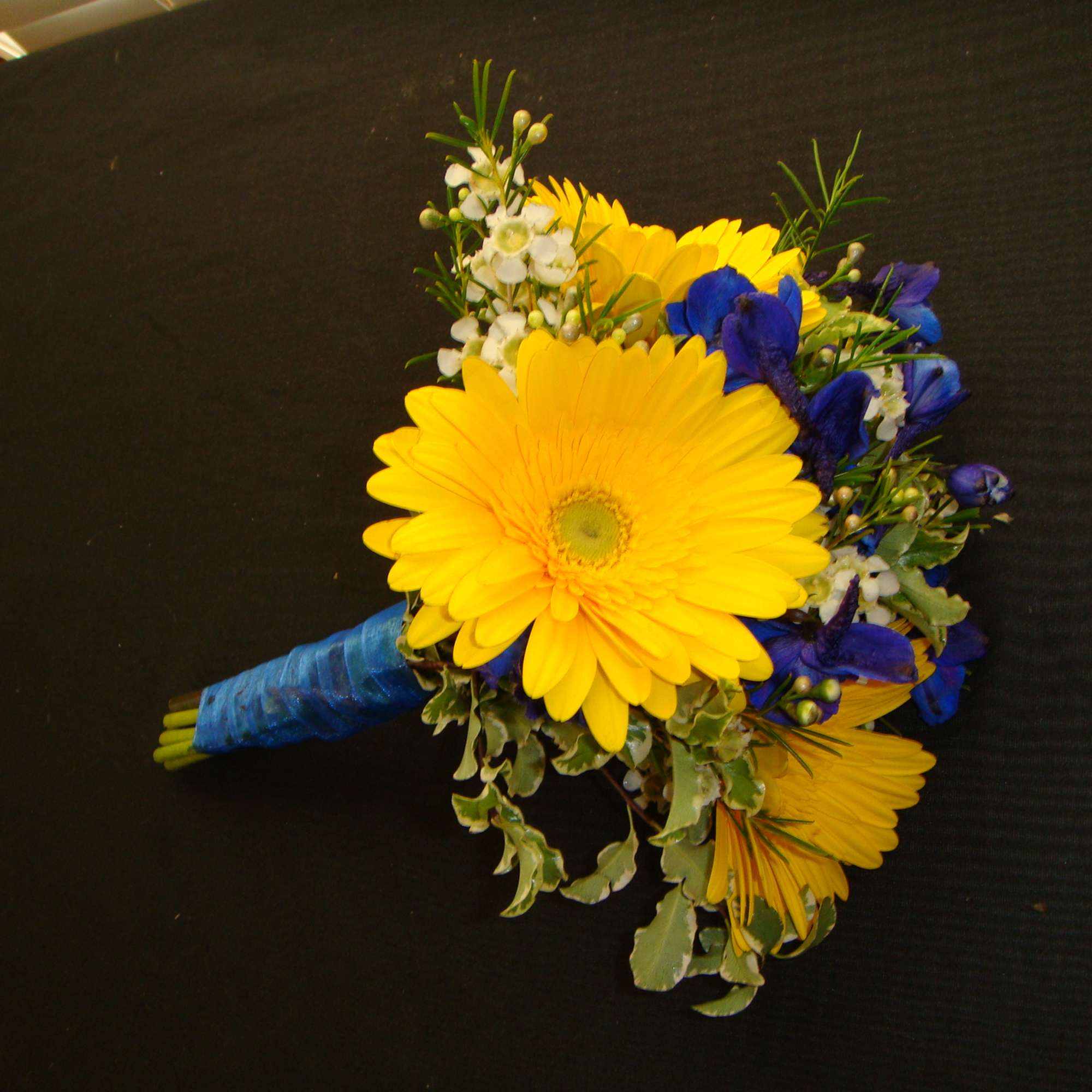 Yellow gerbera bouquet with blue flowers and white filler