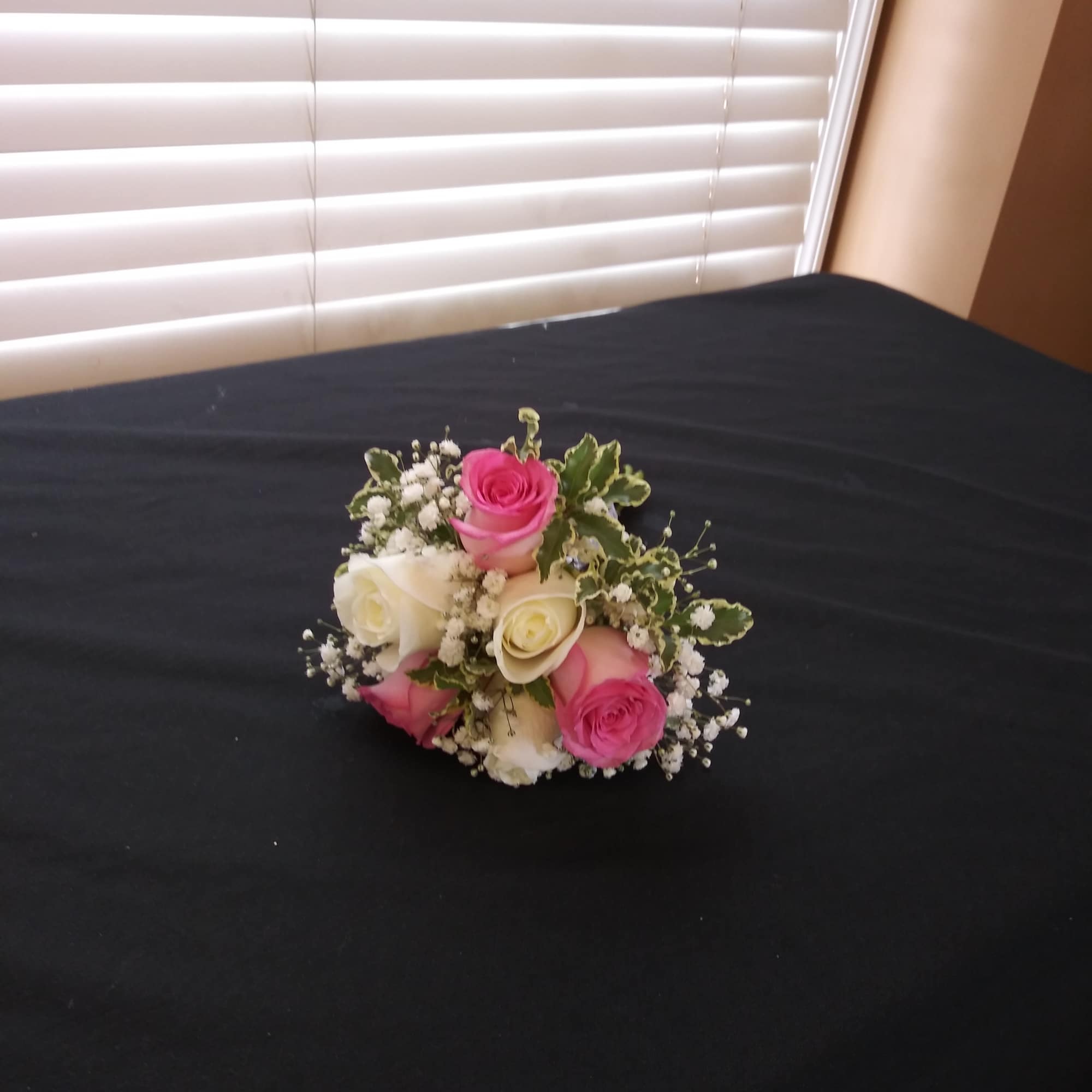 Small bouquet of pink and white roses with baby's breath