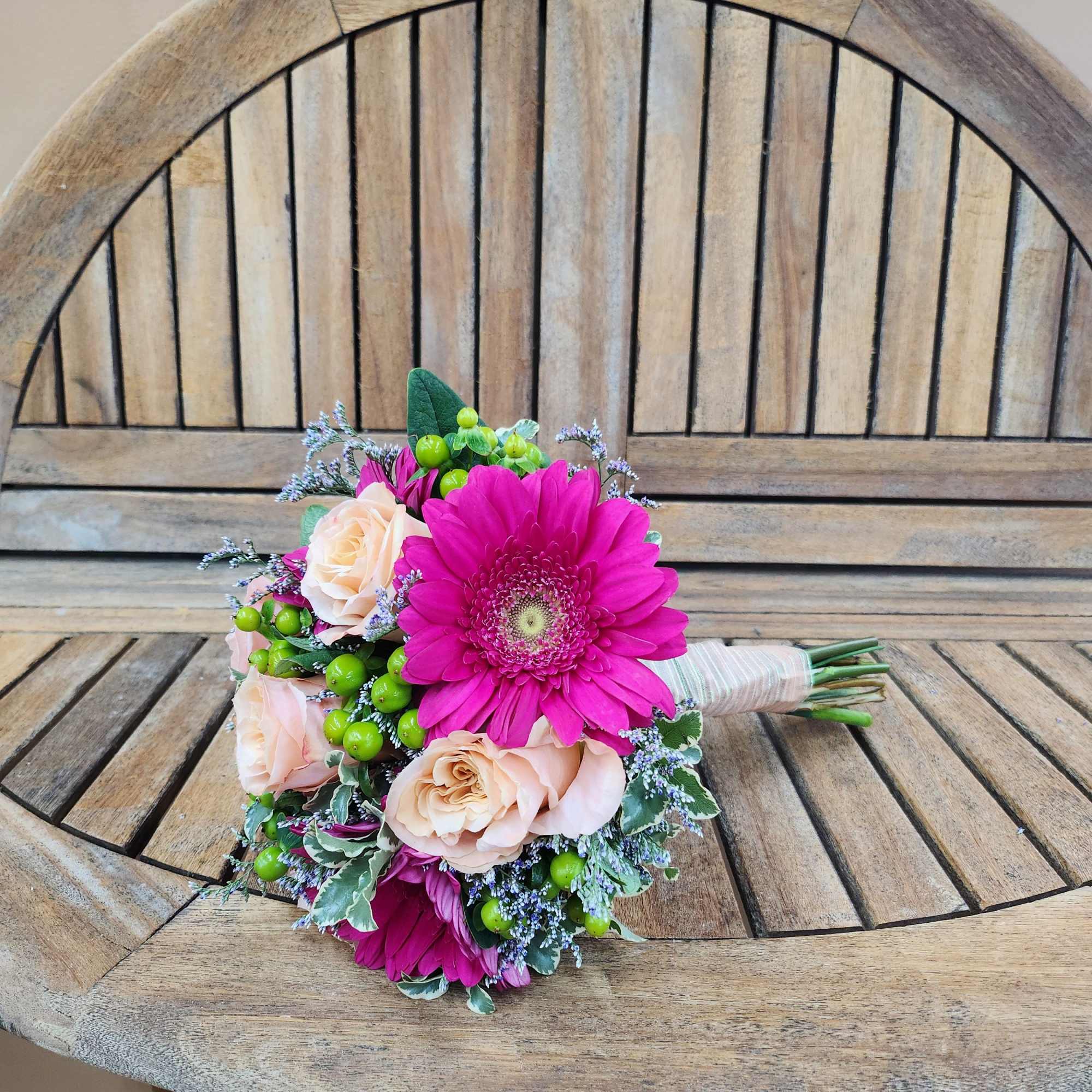 Hand tied bouquet of Gerber daisies and roses.