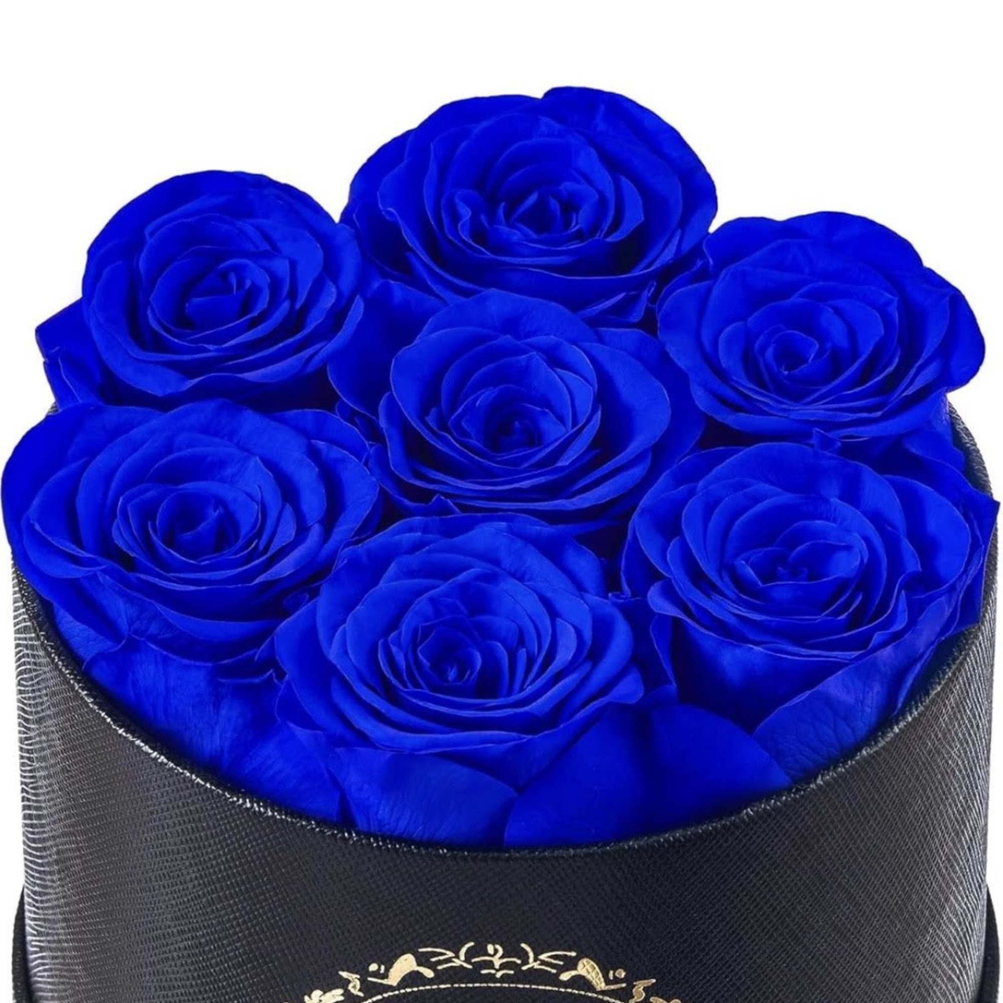 Round black box filled with vivid blue roses in a tight clustered arrangement