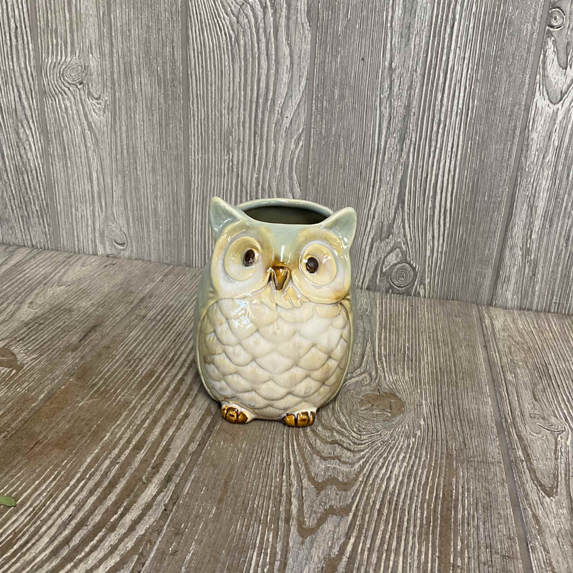 Small owl-shaped ceramic container with a round opening on top