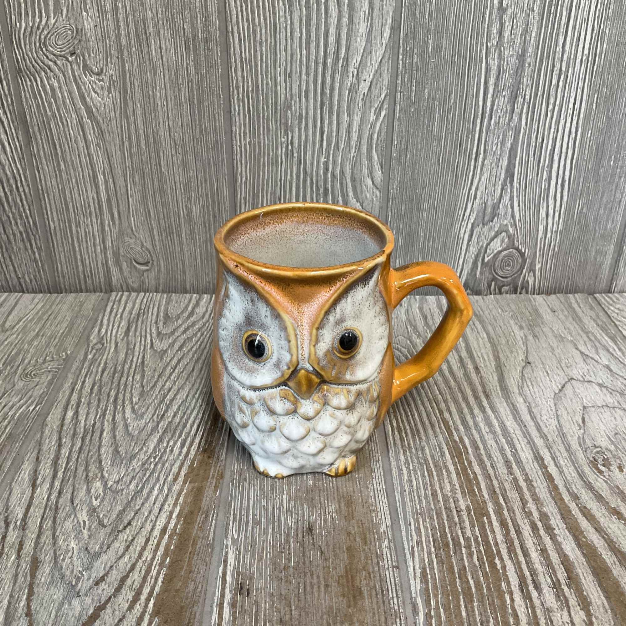 Ceramic owl mug filled with sunflowers. 