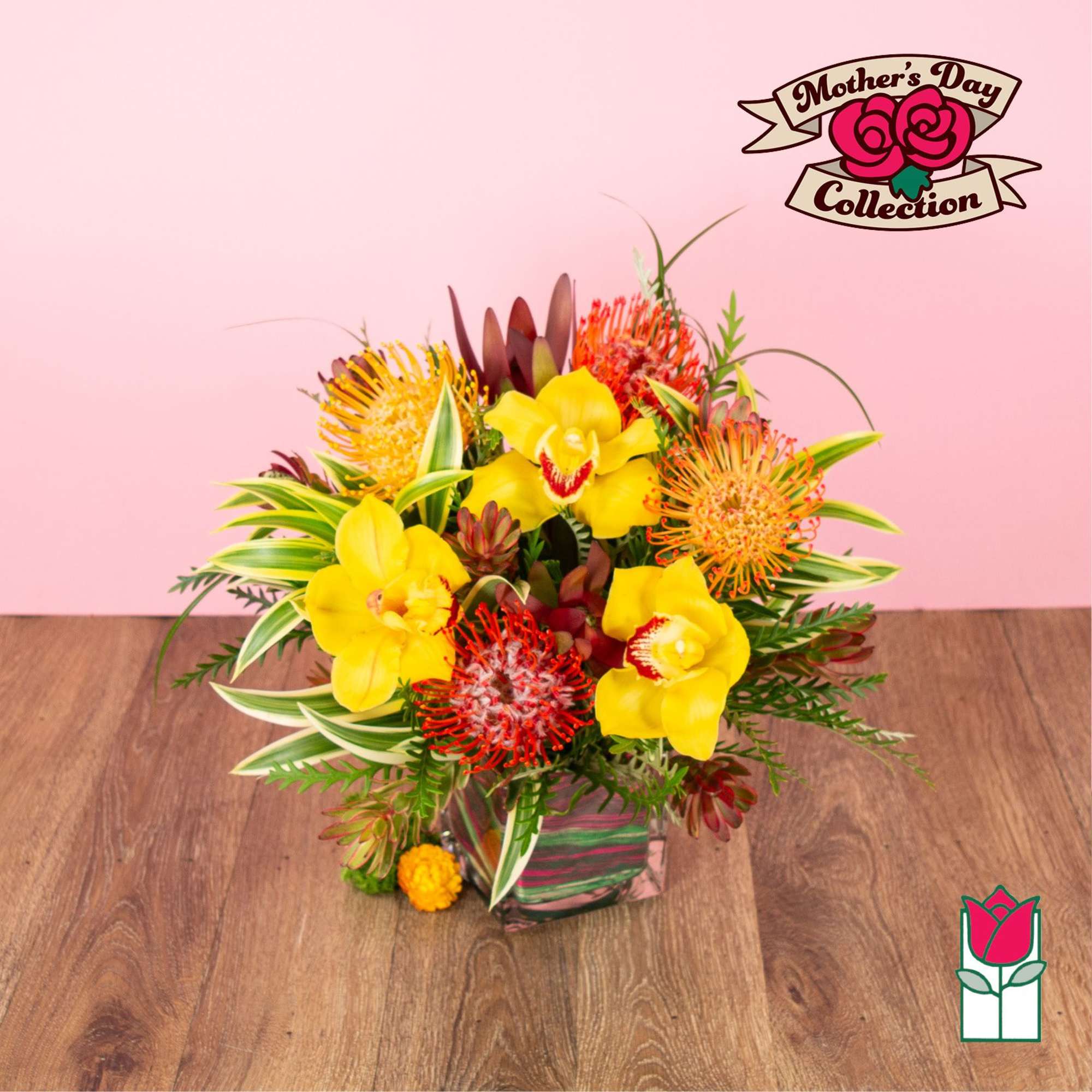 Bright arrangement with yellow orchids and orange pincushion protea in a square glass vase