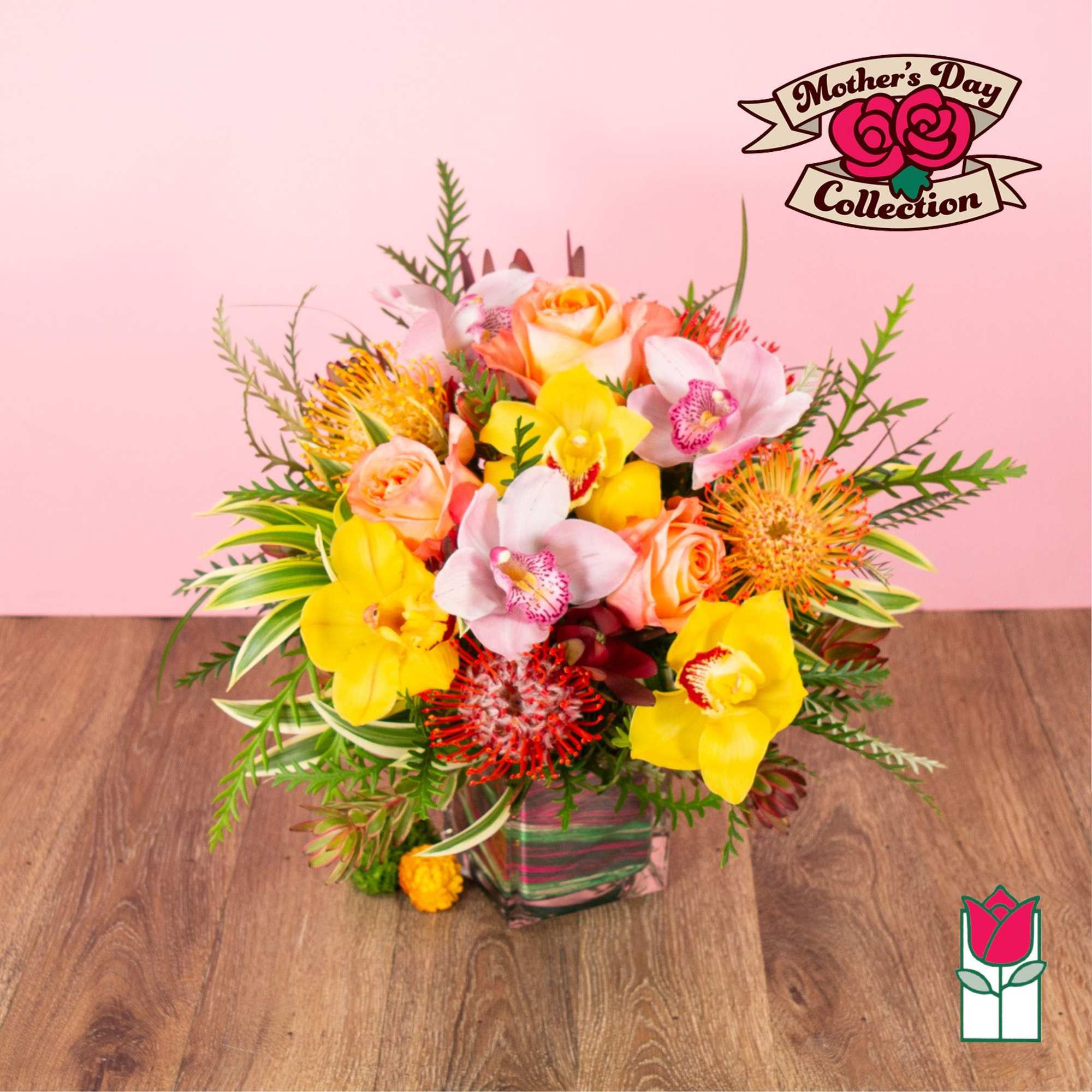 Bright arrangement of yellow orchids, peach roses, and orange protea in a square glass vase